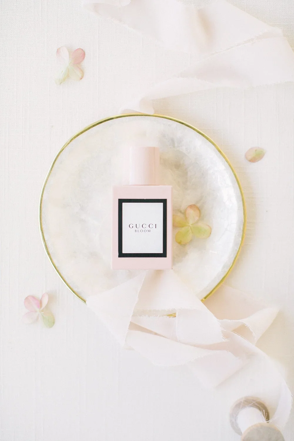 wedding perfume styled with ribbon and a marble tray