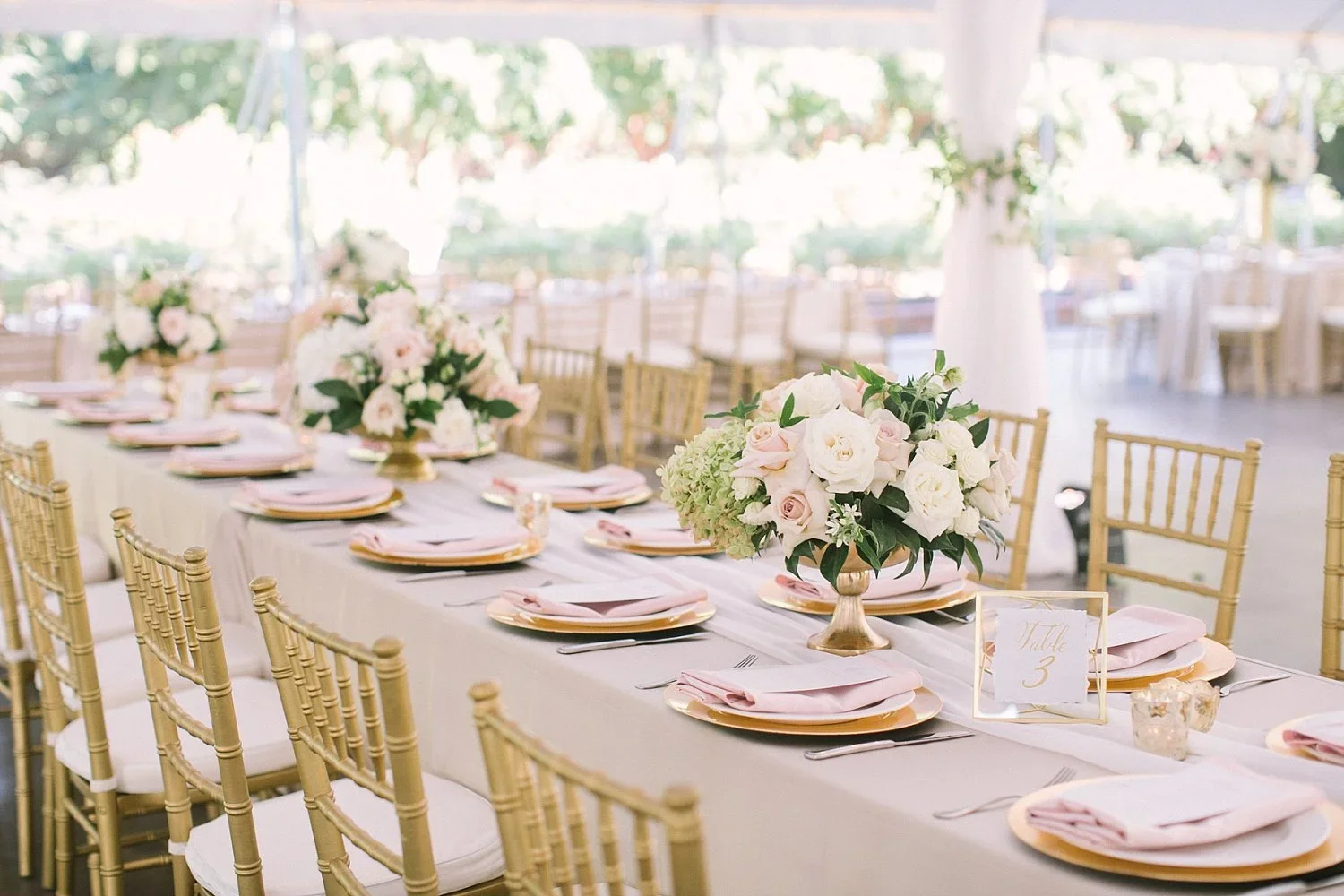 Long rectangle table with romantic flowers and blush napkins