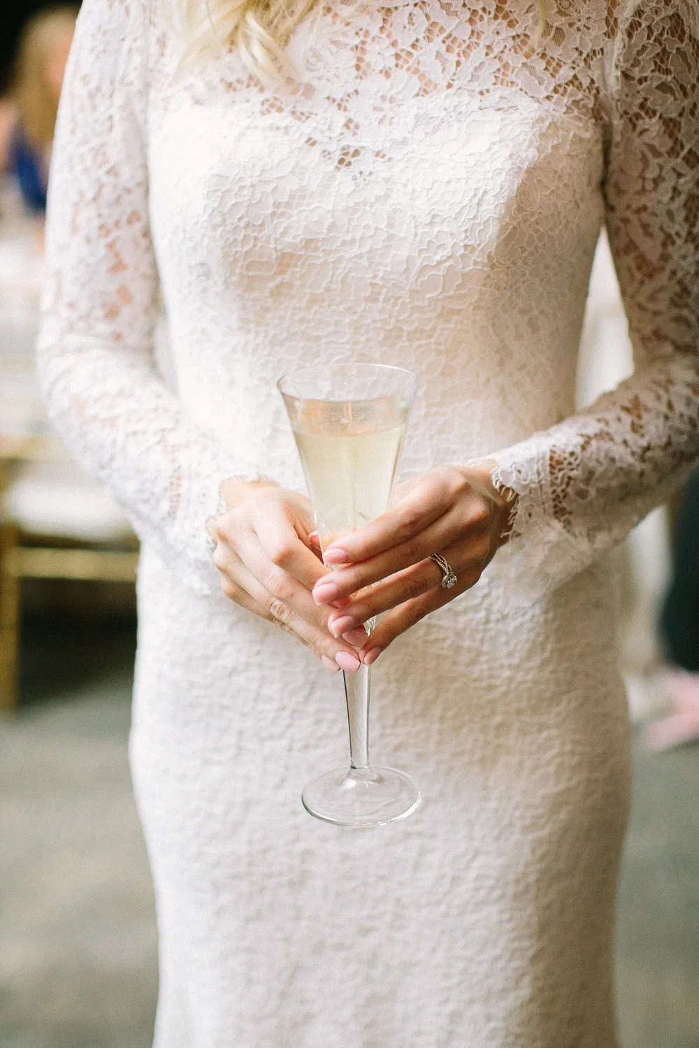 Bride holding glass of champagne