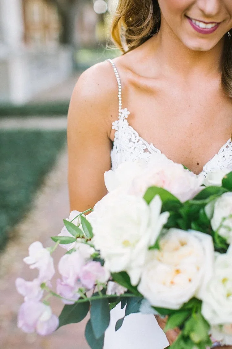 Bride holding a blush and white bouquet
