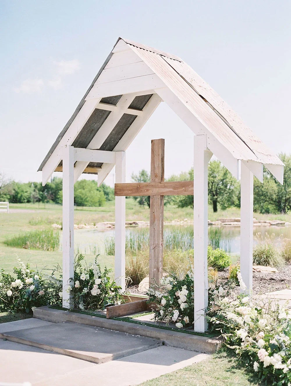 The Nest at Ruth Farms Ceremony with wood cross and floral halo