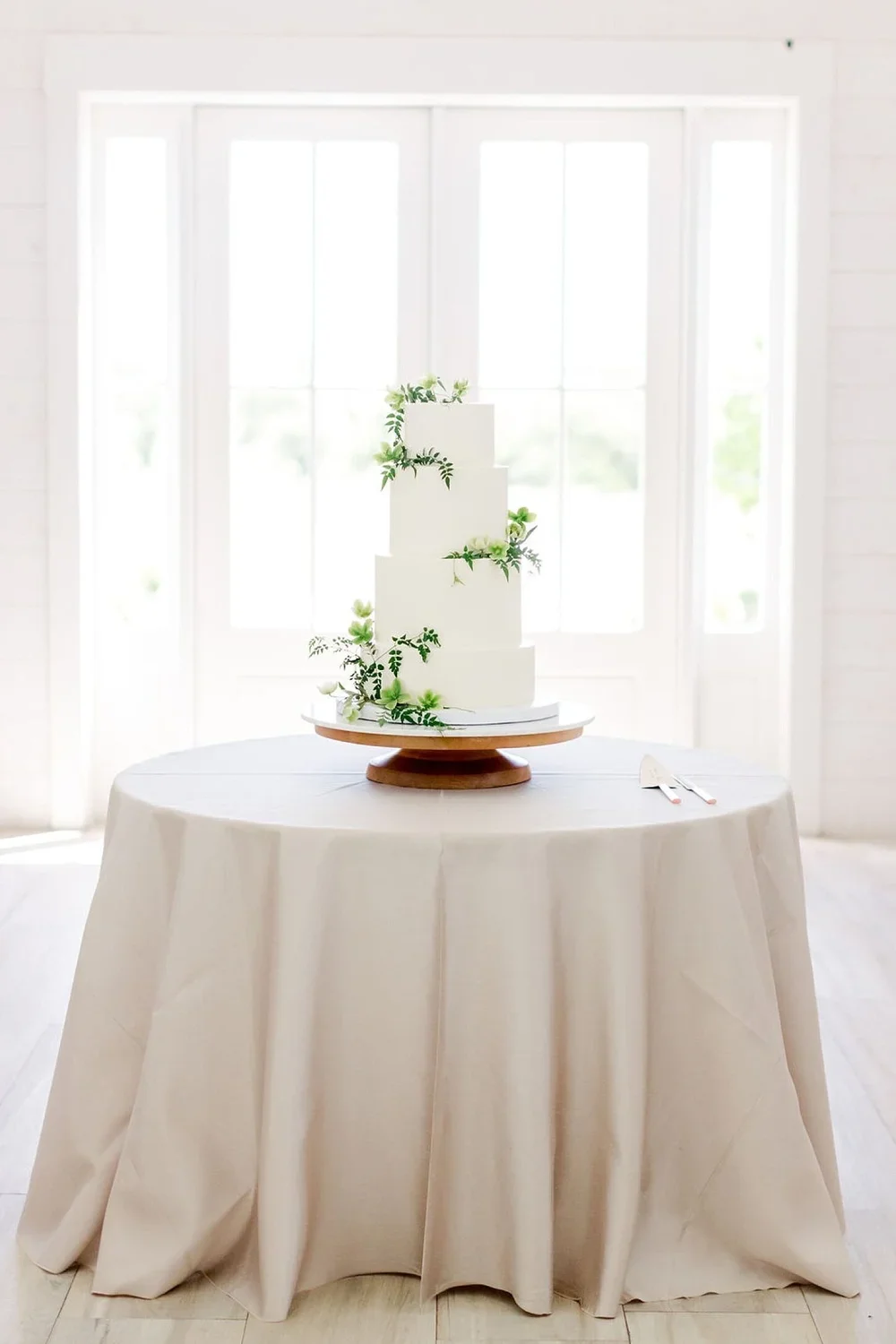 Natural clean organic wedding cake on a wood cake stand