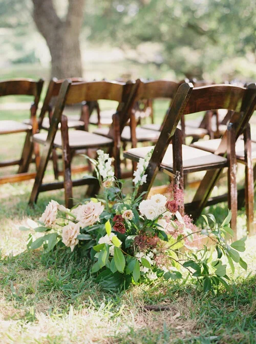 Organic red and pink aisle flowers on ground at Austin Wedding