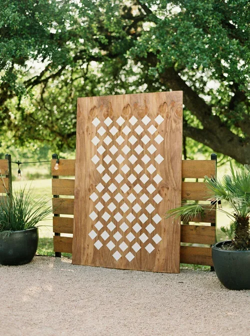 Large boho wood seating chart with escort cards in a pattern