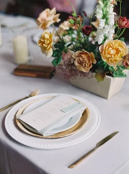 Wood plate place setting with yellow flower wedding centerpiece