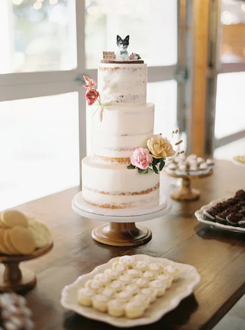 Naked cake with Dog Topper on a Farm Table