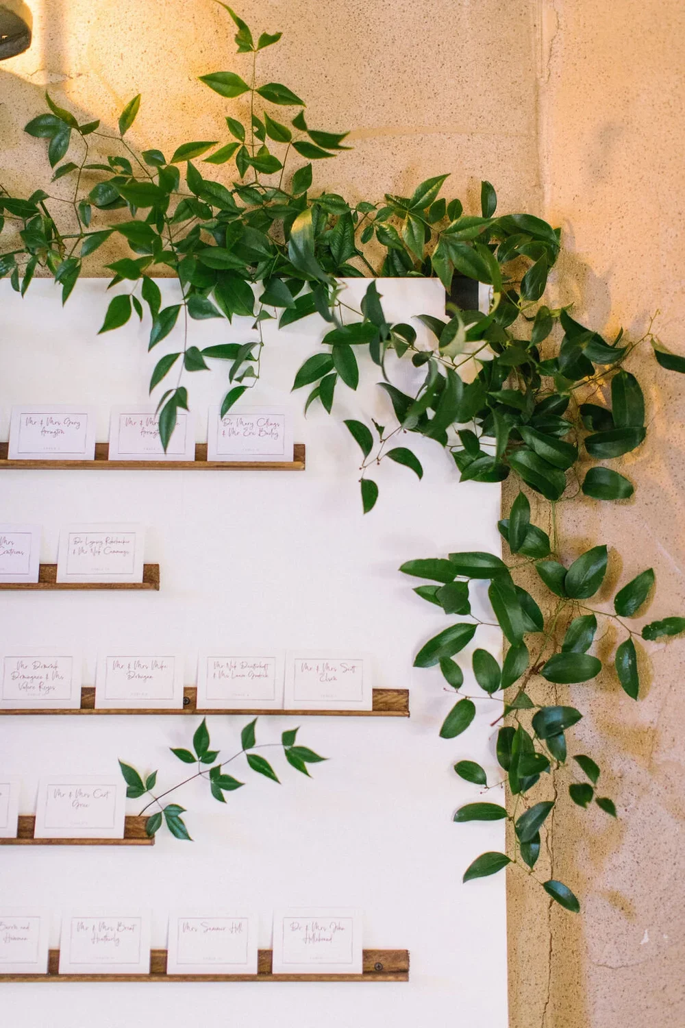 White farmhouse inspired seating chart with wood float shelved