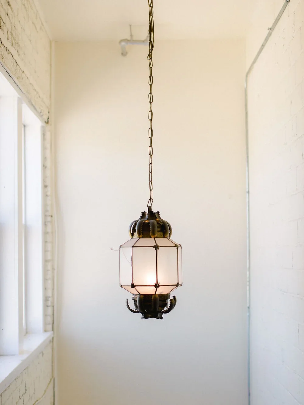 Brass pendant light in industrial wedding venue
