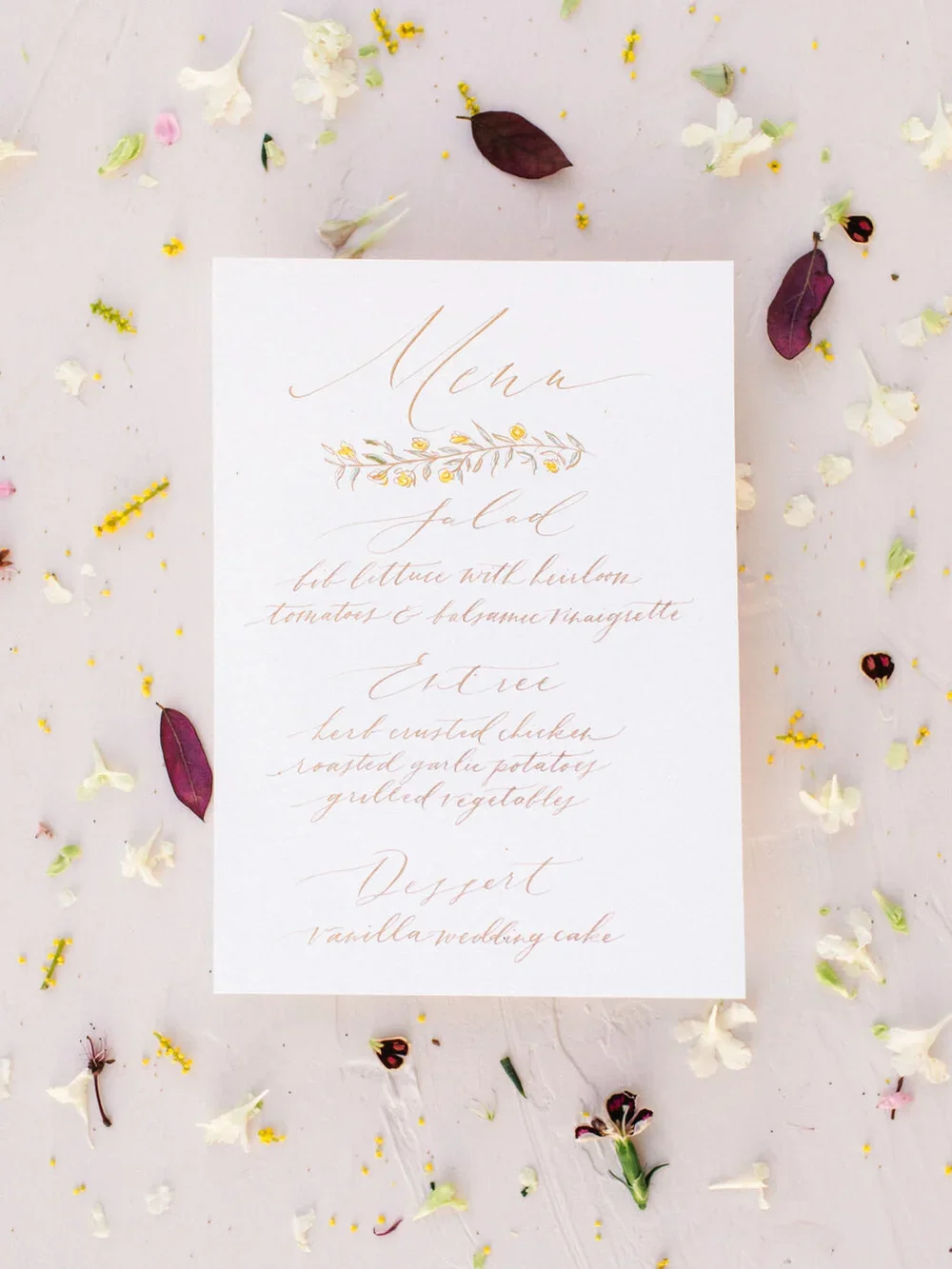 Calligraphy menu with gold text &amp; outline flower designs with filled in yellow