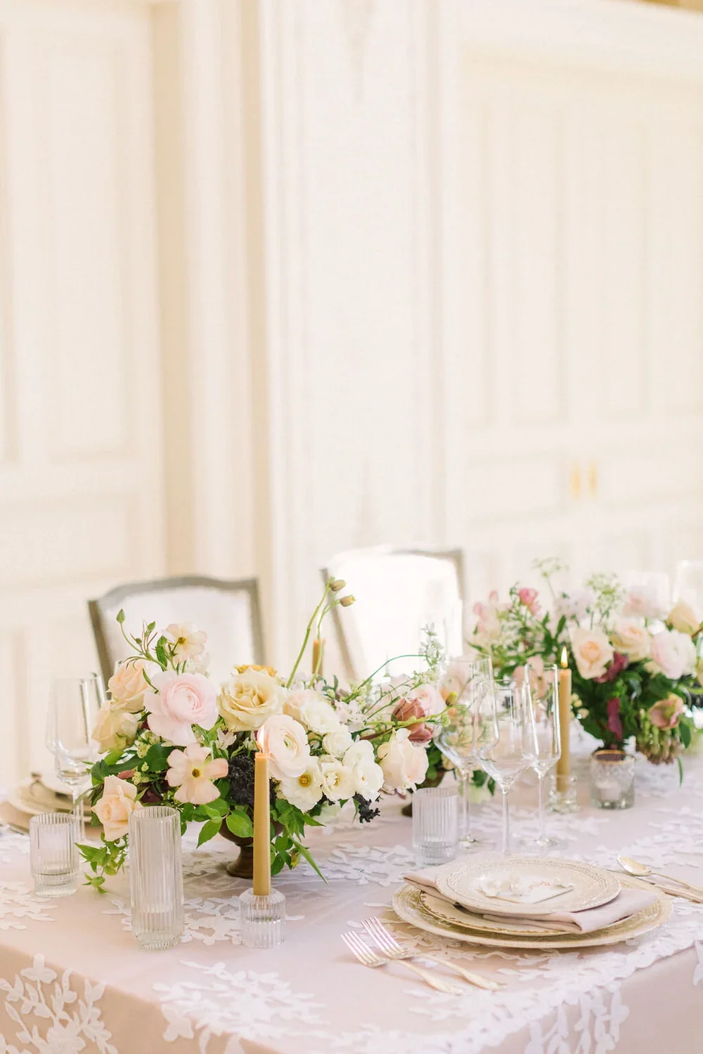 Pink table setting with yellow &amp; purple flower arrangement
