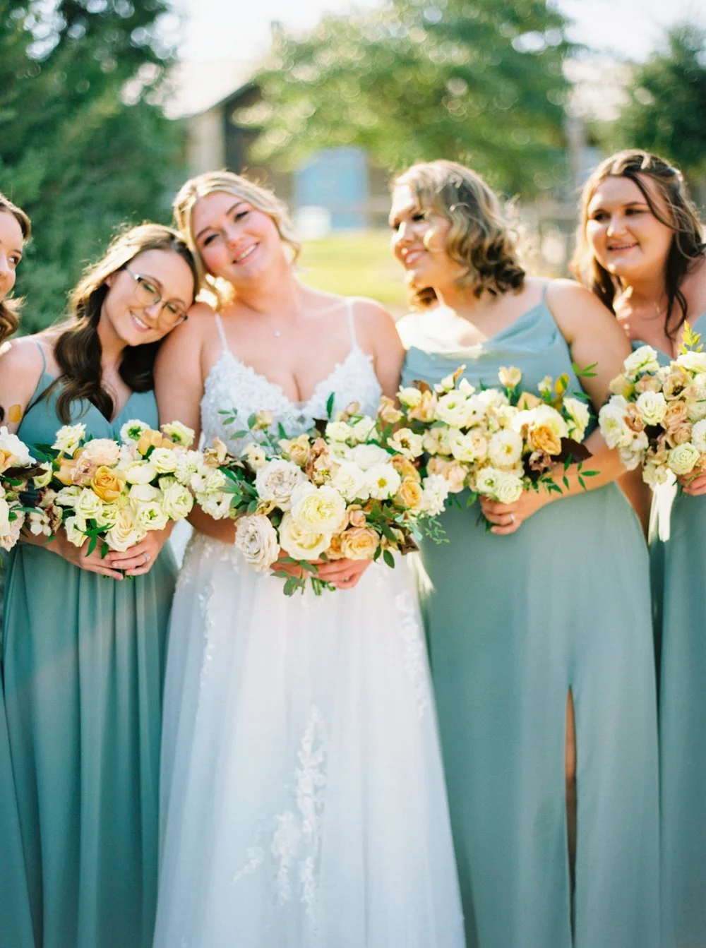 Bridesmaids with Sage green dresses and yellow flowers