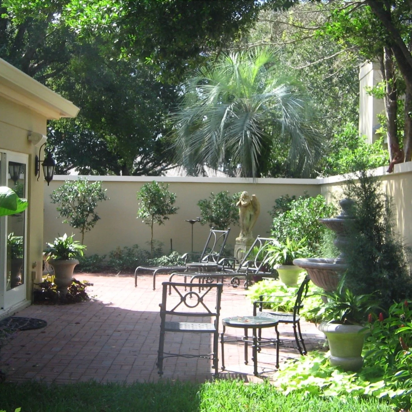 A quiet garden retreat inspired by timeless tropical design. 🌿

This Bay Hill courtyard was designed as a private escape blending layered palms, classical garden elements, warm brick paving, and a custom pergola to create a space that feels both int