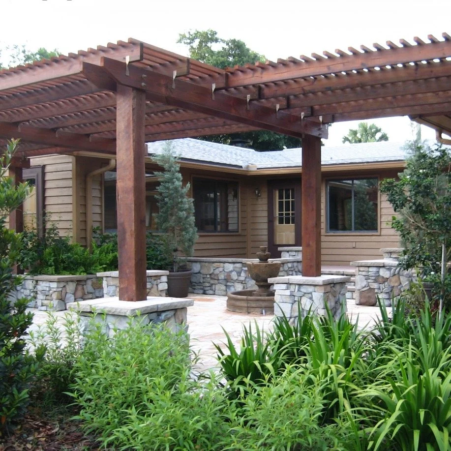 Strong architectural structure paired with natural materials.

This ranch estate project was designed around a series of connected outdoor rooms featuring custom timber pergolas, natural stone paving, raised masonry planters, and a central fountain c