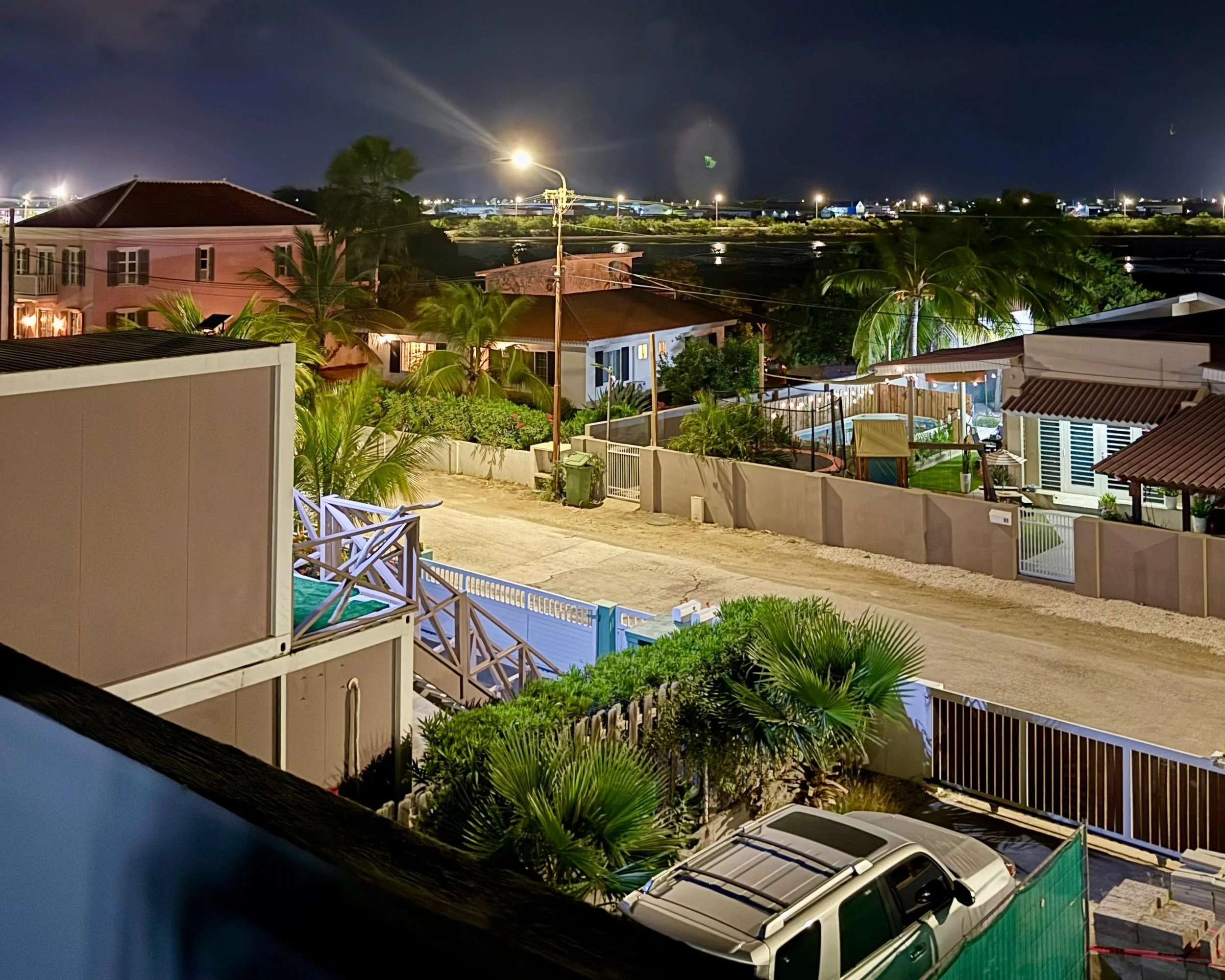 Overview of Kas Pitava’s rooftop area and nearby pool, with night city lights in the background.