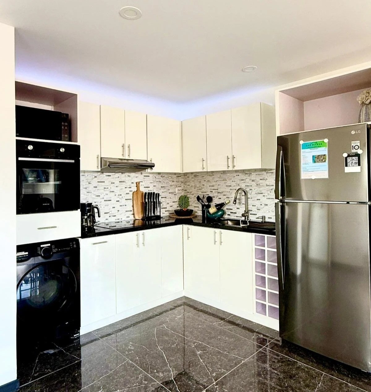 Fully equipped modern kitchen at Kas Pitava with tiled backsplash and stainless steel appliances.