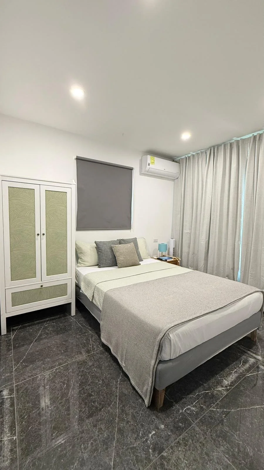 Kas Pitava, Guest bedroom featuring a full-size white bed and soft lighting for a peaceful stay.