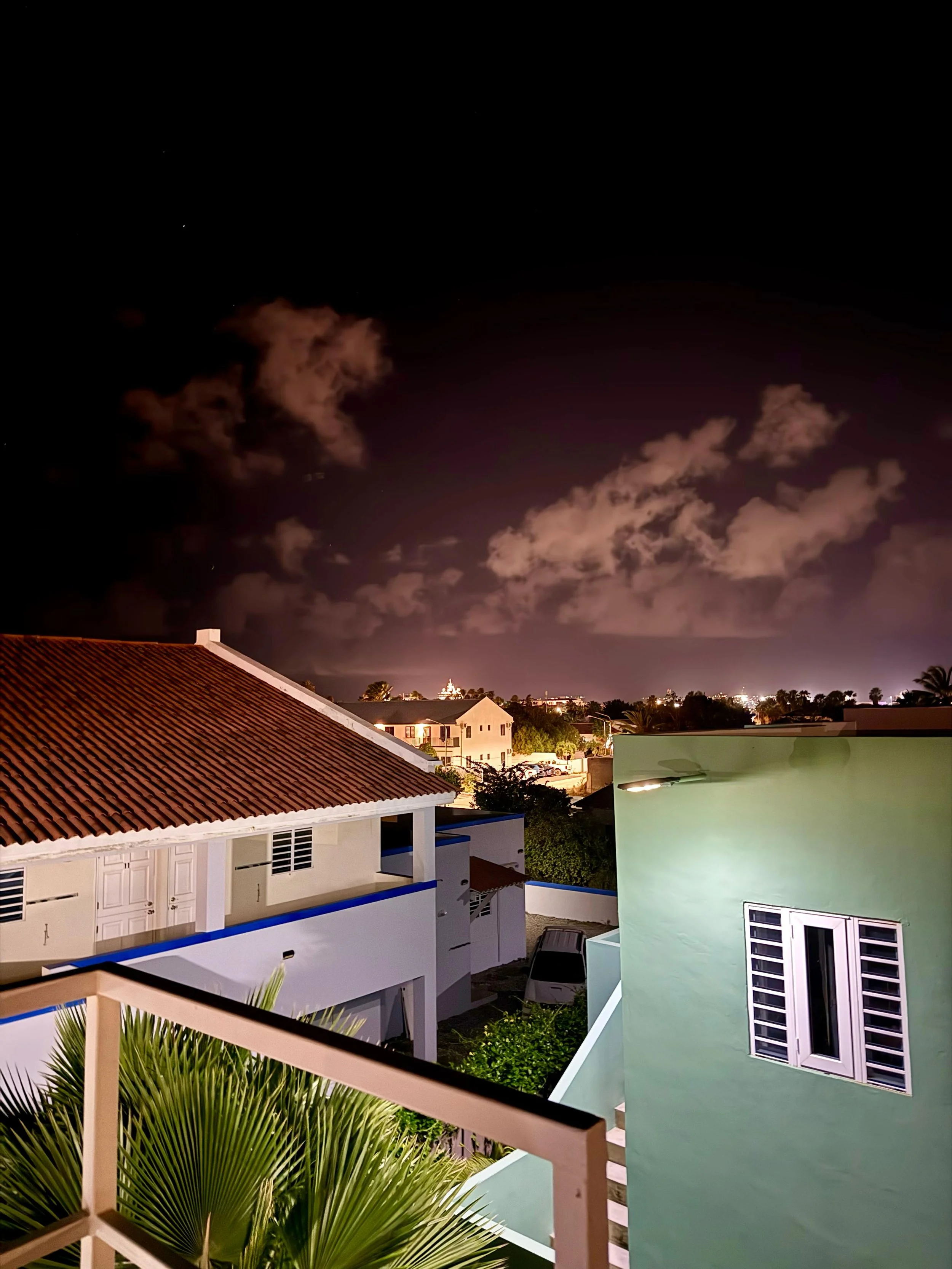 Breathtaking view of the night sky over Kas Pitava’s rooftop with dramatic purple clouds.