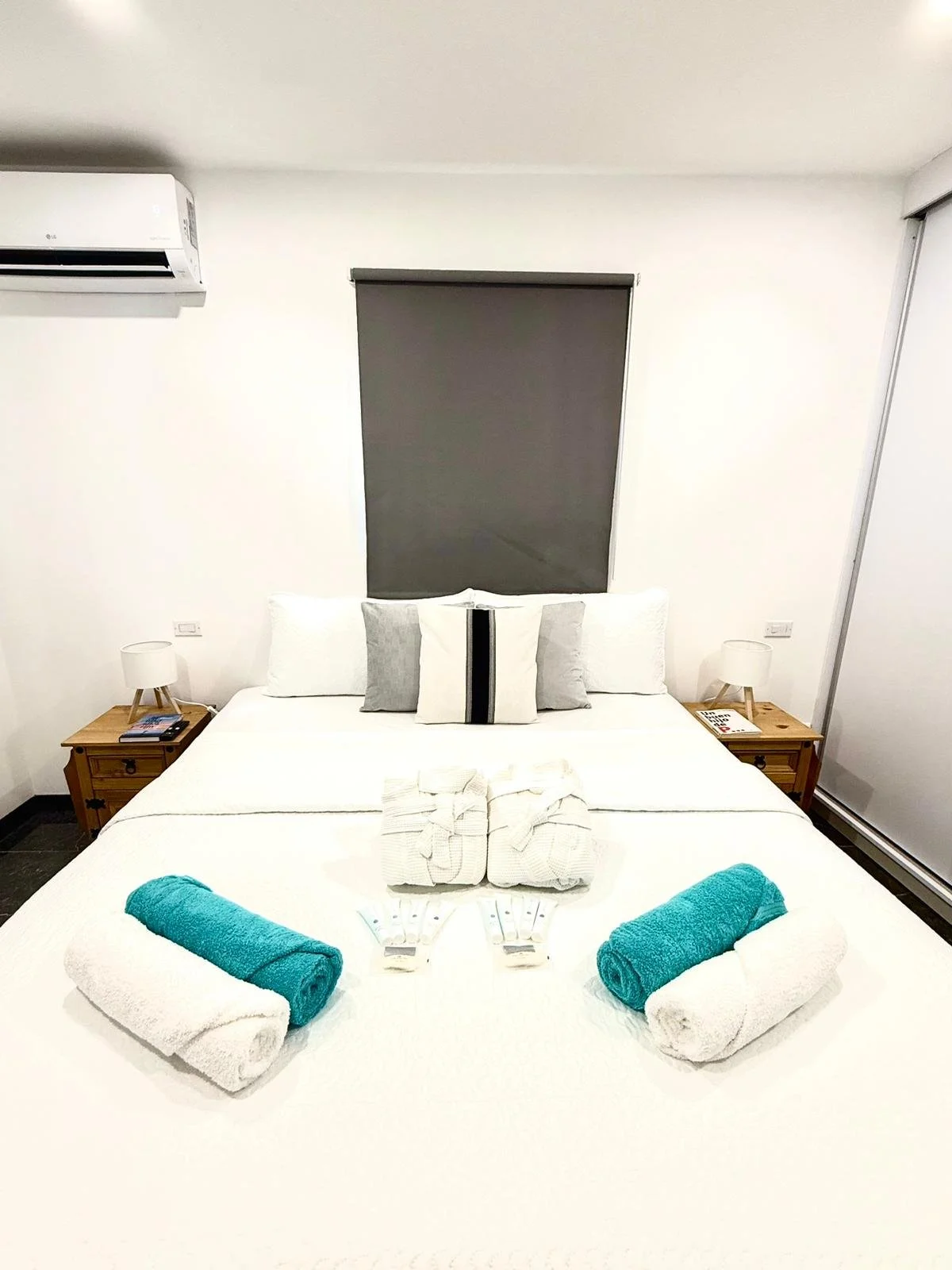 Kas Pitava, Bonaire, King-size bed with crisp white linens and elegant grey accents.