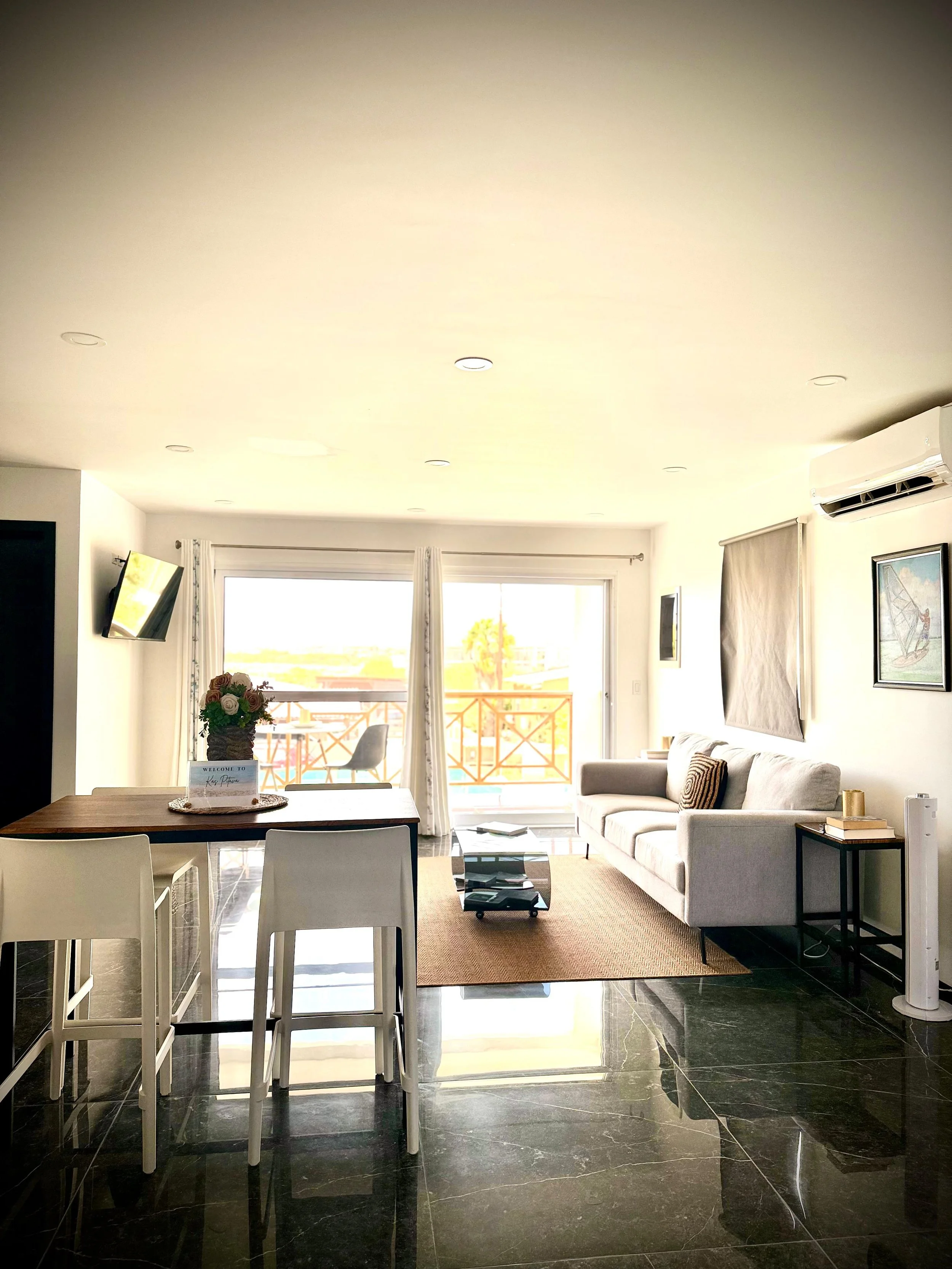 Open kitchen and dining area at Kas Pitava with breakfast bar and access to the balcone.