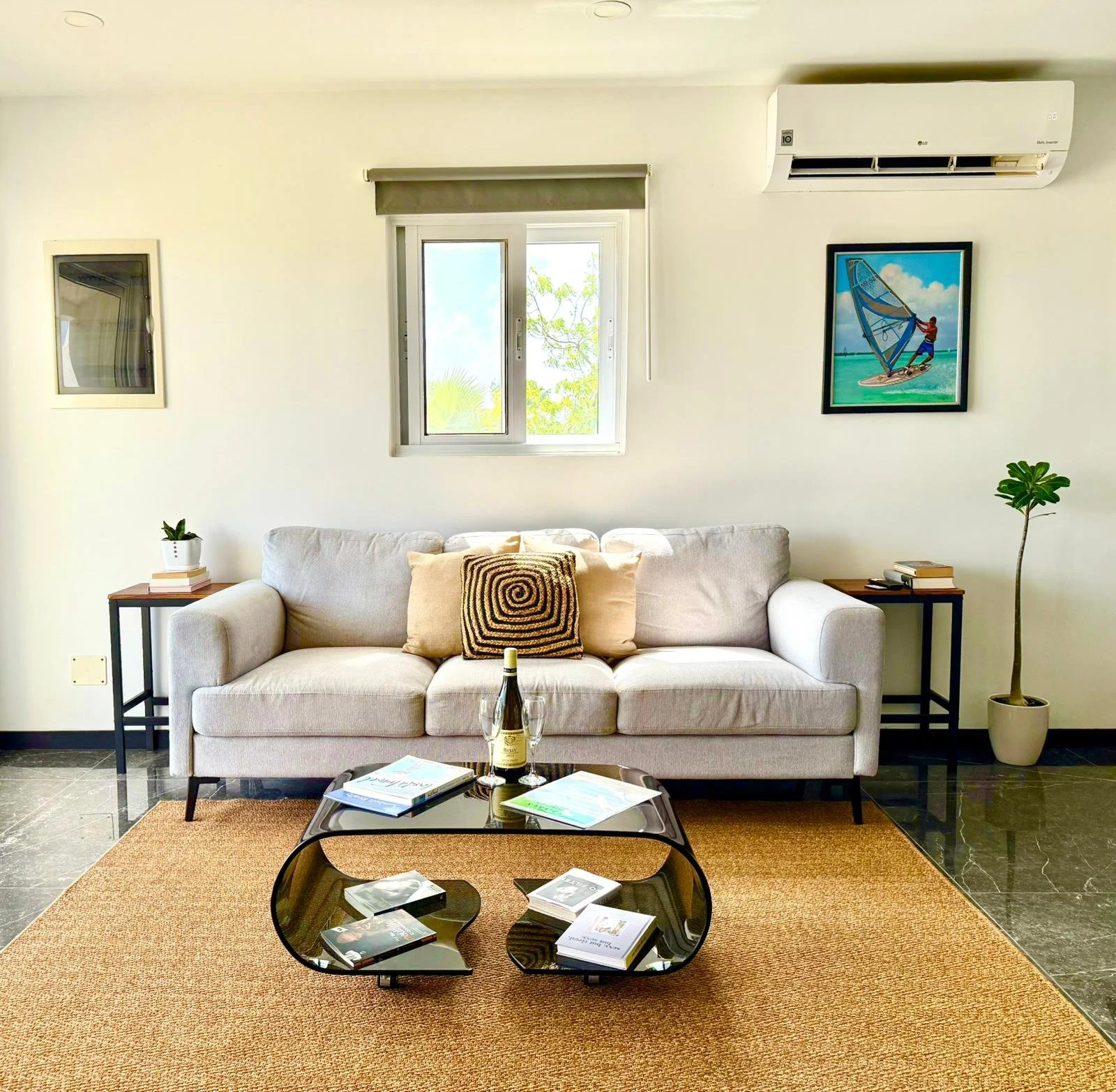 Stylish sitting area at Kas Pitava with air conditioning, tropical artwork, and natural tones.