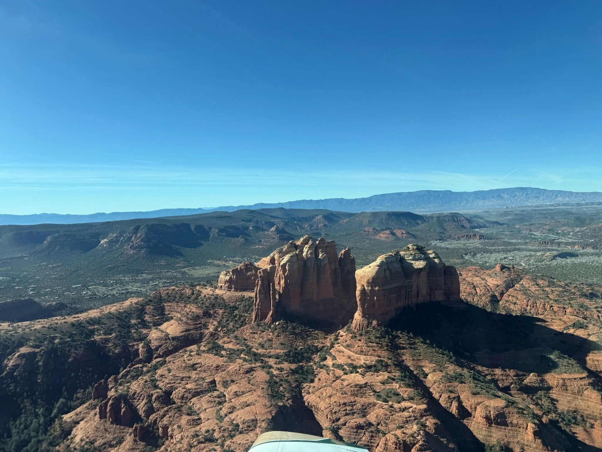 Air tour plane over Sedona canyon and rock formations