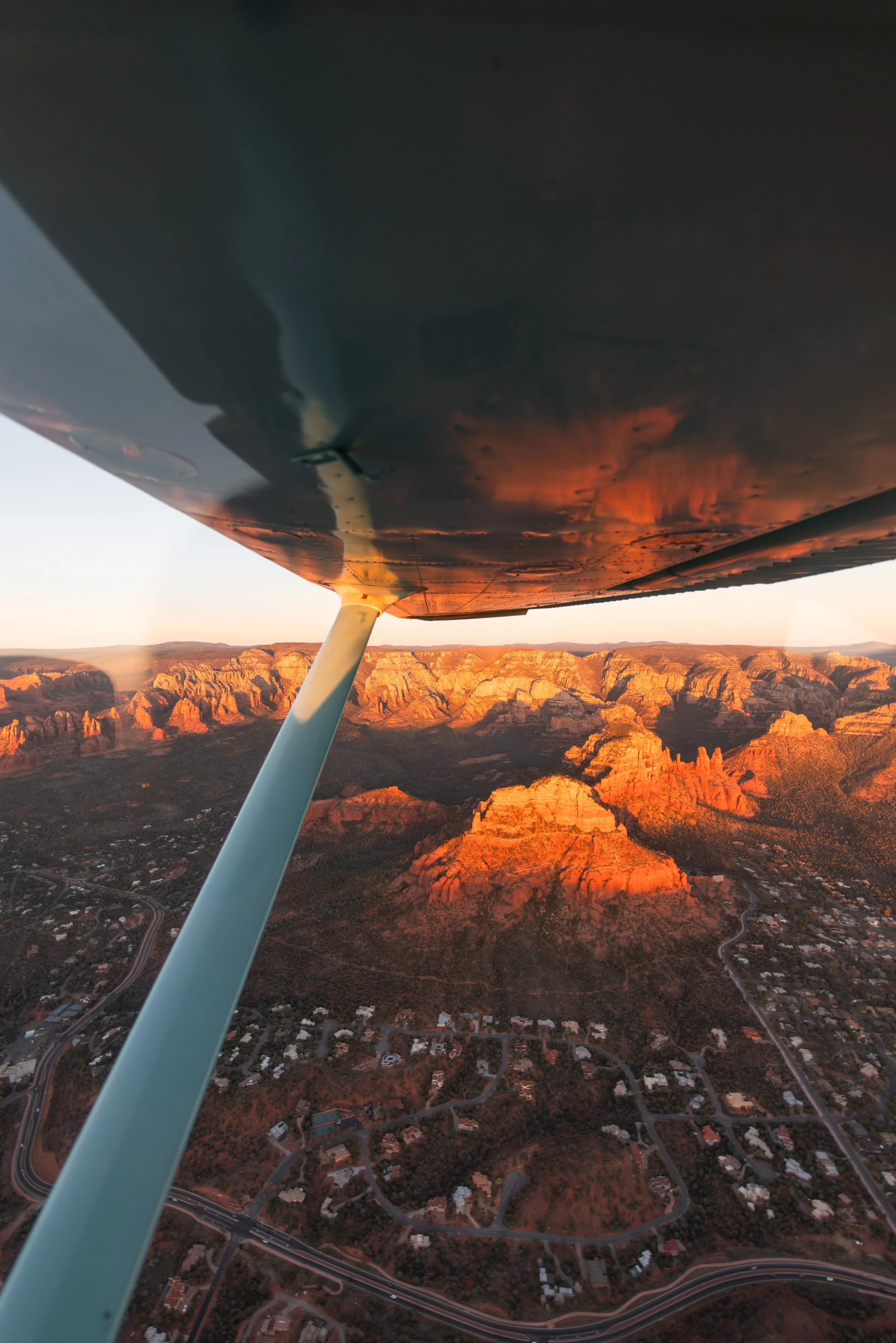 Sunset aerial view of Sedona red rocks glowing orange