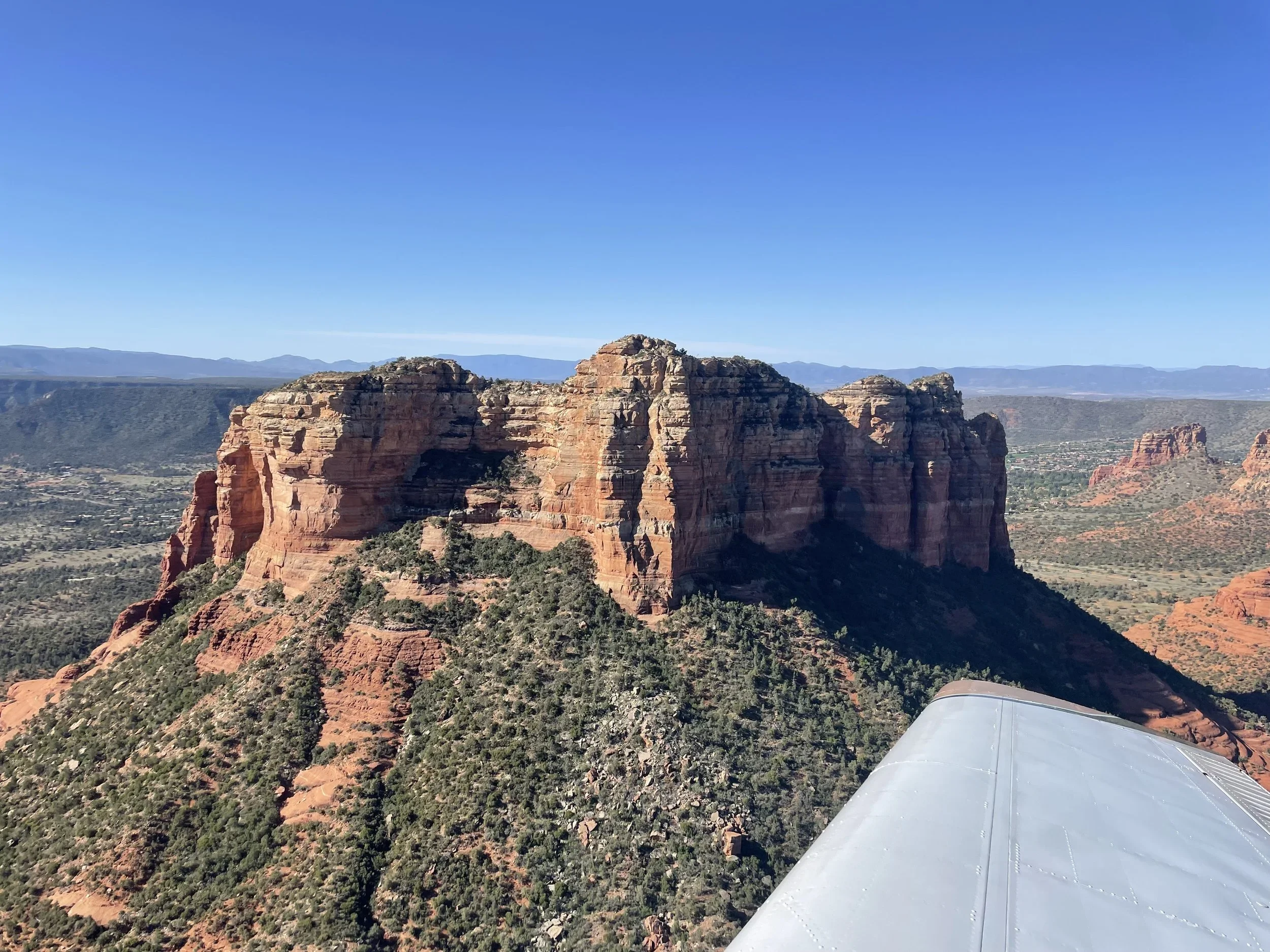 Small aircraft above Sedona red rock formations