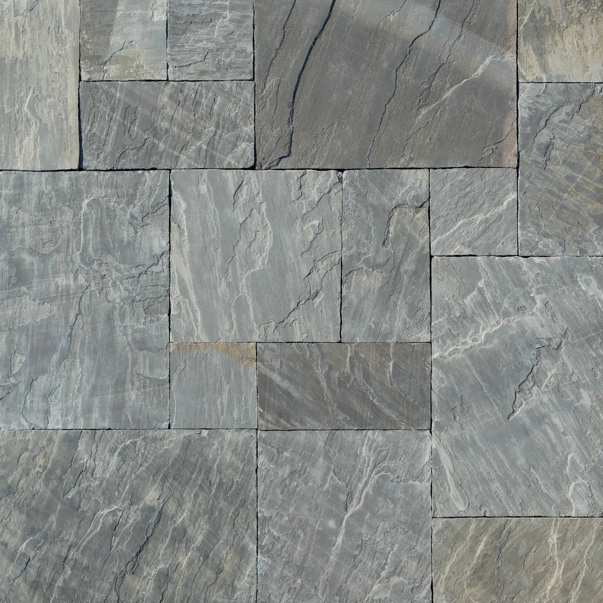Close-up view rectangular grey Cragside or Sable flagstone, arranged in a pattern, showing natural veining and texture.