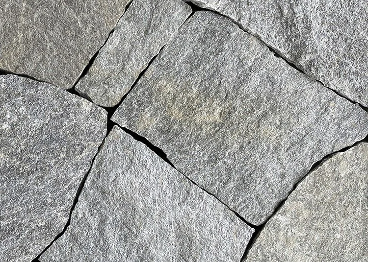 A natural stone mosaic veneer featuring warm gray tones.