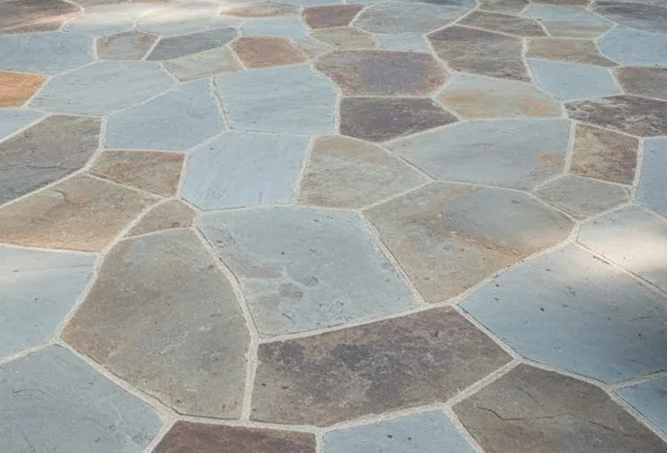 Close-up of irregular PA Cleft Flagstone patio in various shades of gray and brown.