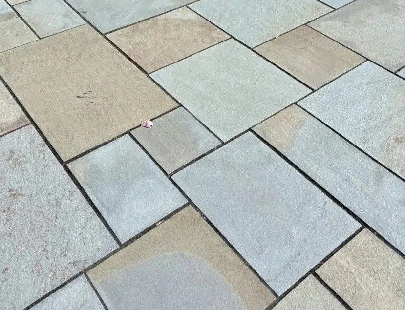 Close-up of multi-colored PA Rustic Thermal Flagstone arranged in a patio.
