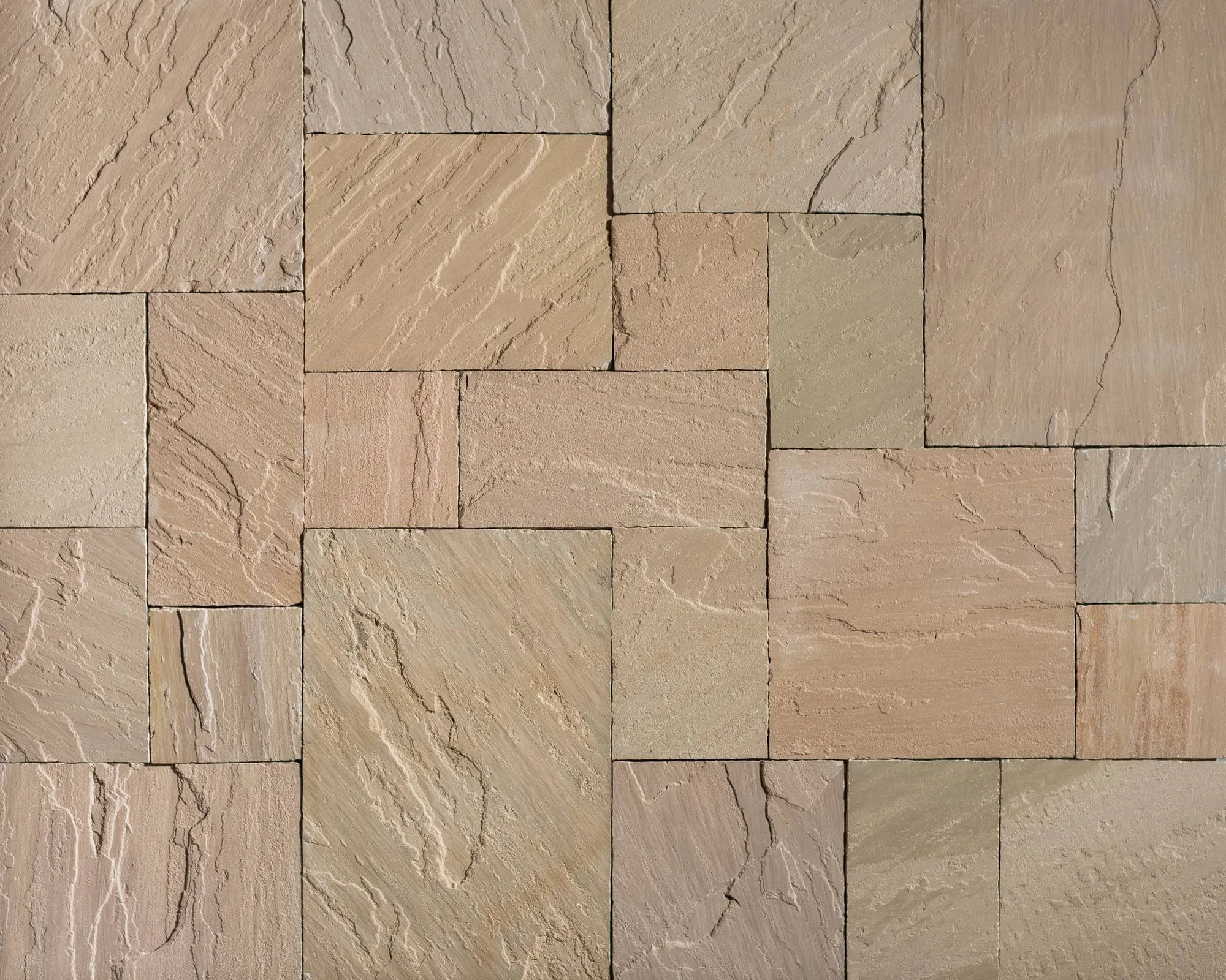 Close-up of Autumn Brown flagstone various textured and patterned rectangular stone, arranged in a grid.