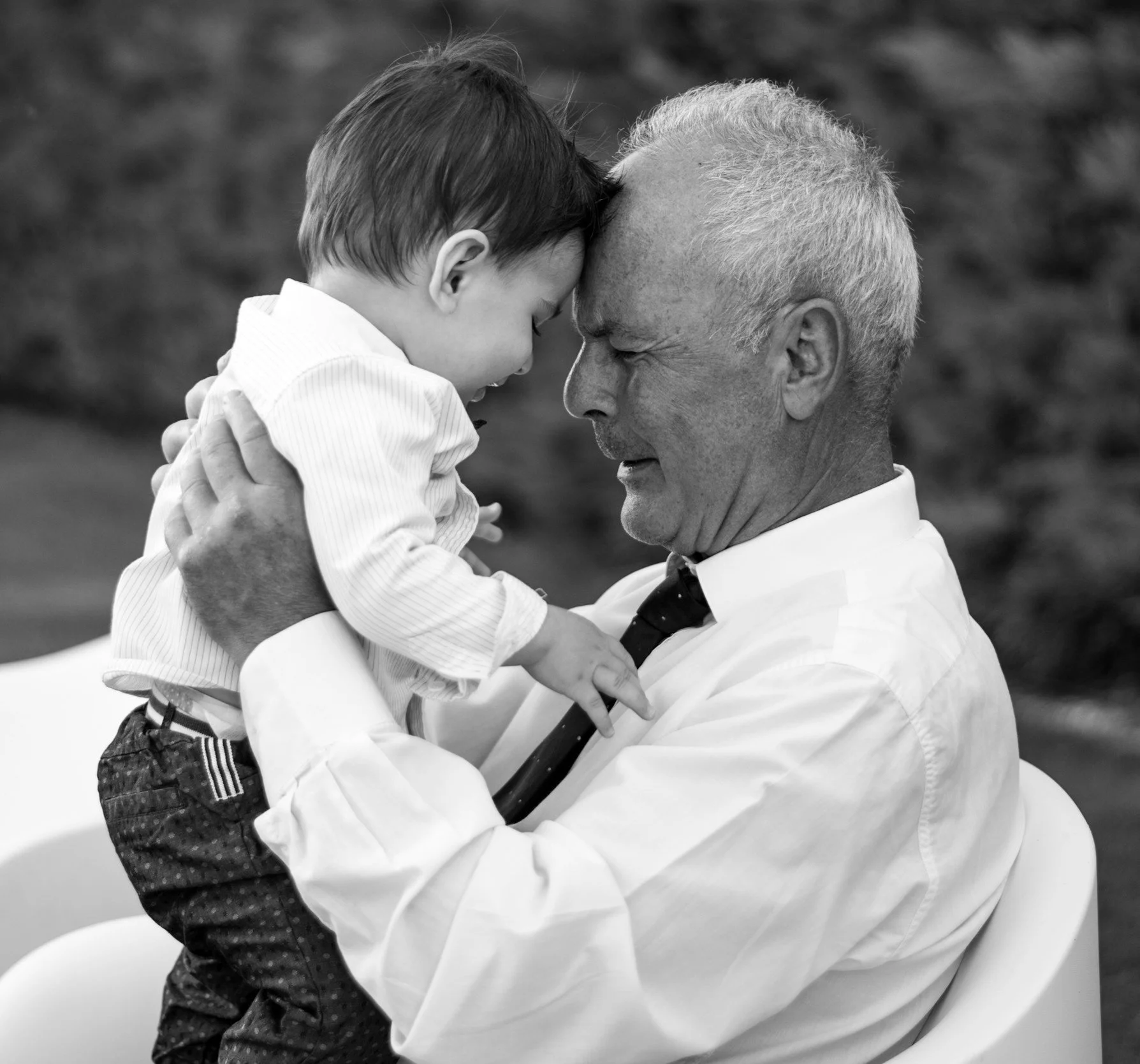Grandfather holding young child in a tender moment representing generational connection