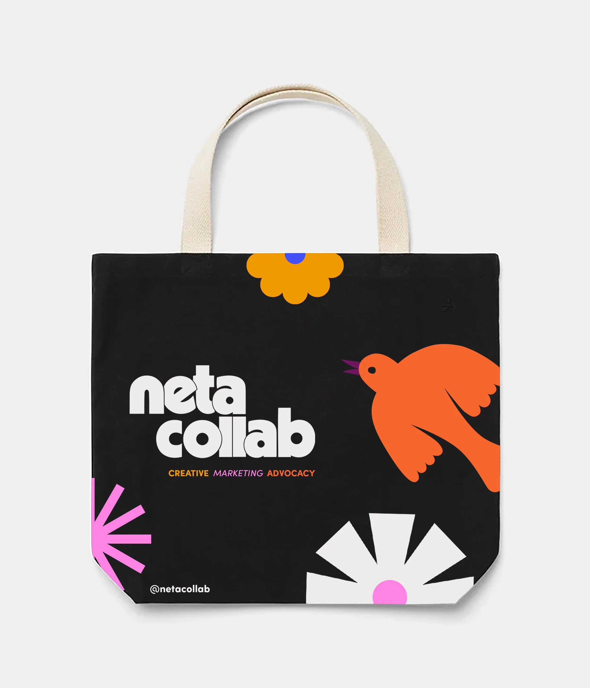 A black tote bag with colorful graphic design and the words '@netacollab' and 'neta collab' printed on it, featuring flowers and a bird illustration.