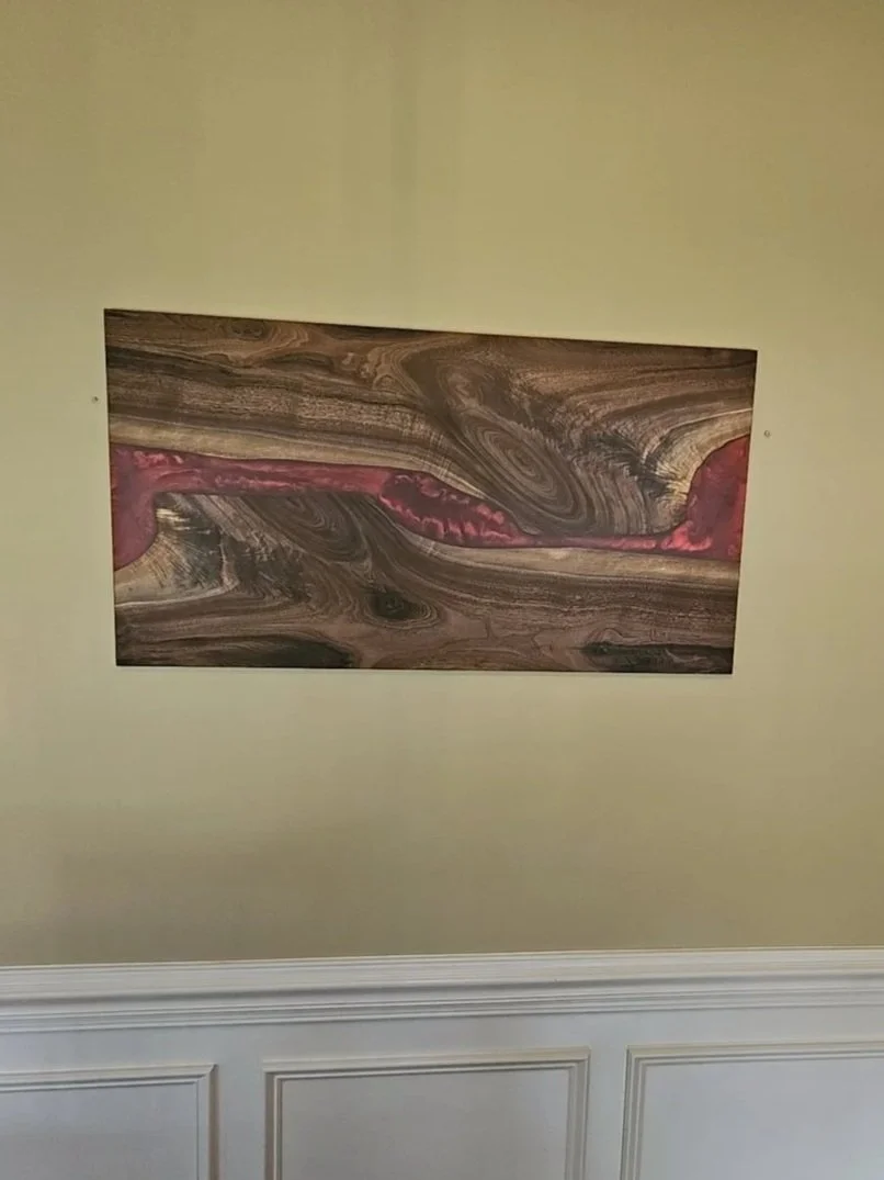 This wall art piece incorporated two highly figured walnut slabs and epoxy tinted with "ruby red" mica powder.