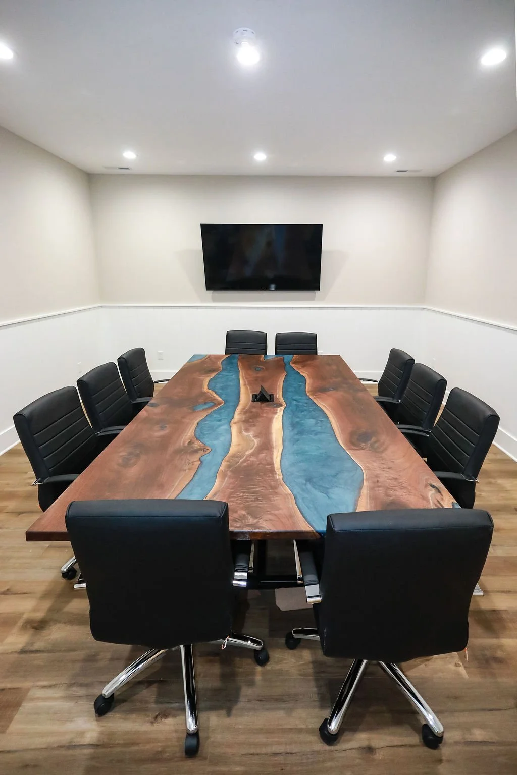 This conference table build consisted of three walnut slabs, two Carolina Blue Rivers, a built-in electronics port, and custom fabricated base with matte black powder coating.  This piece measured 10 ft. x 5 1/2 ft and weights over 350 lbs.