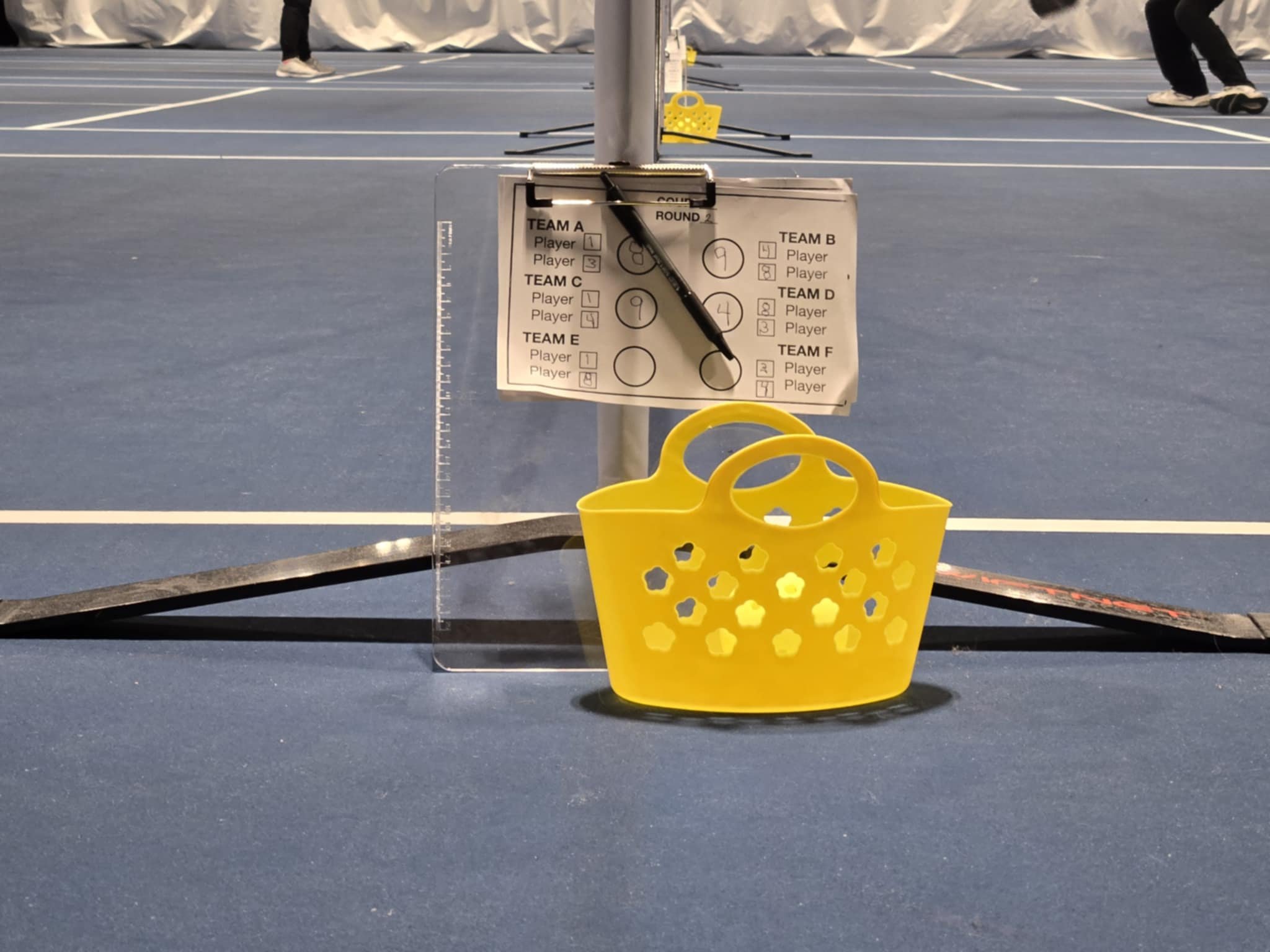 ball basket and score sheets at each court