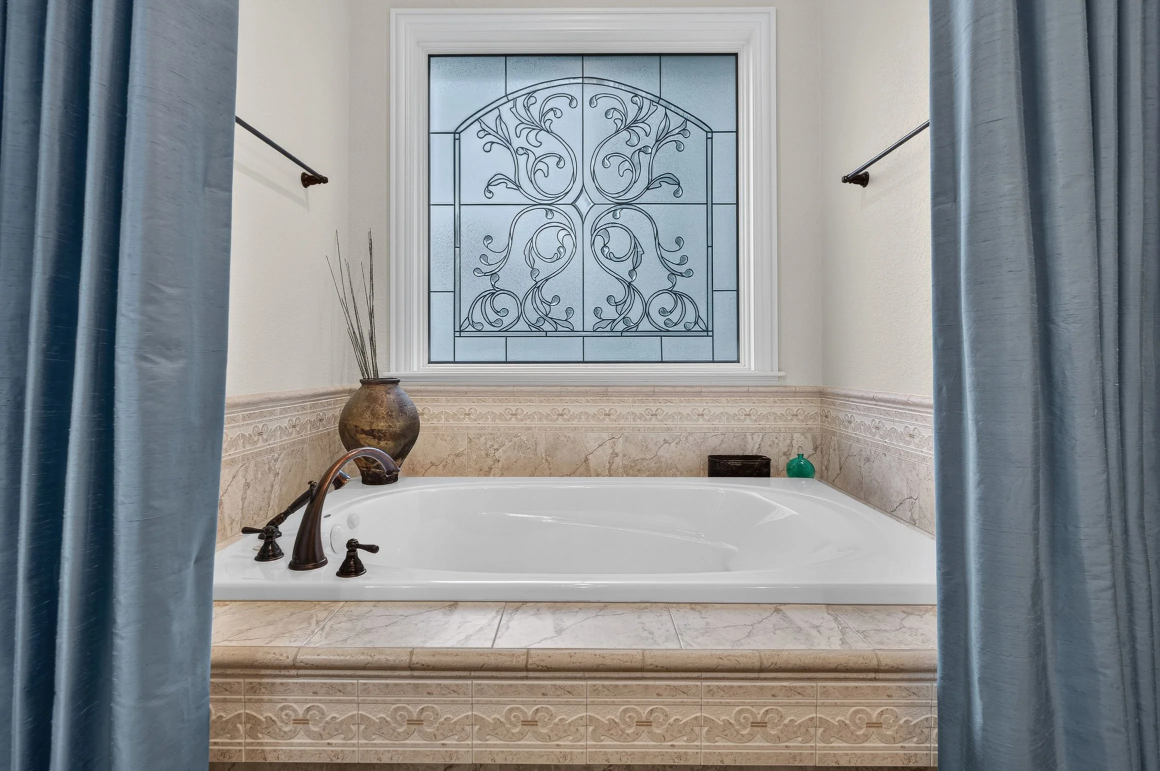 beautiful roman style bathtub design in southeast wisconsin luxury home - Photo credit ©Dream Home Real Estate Media