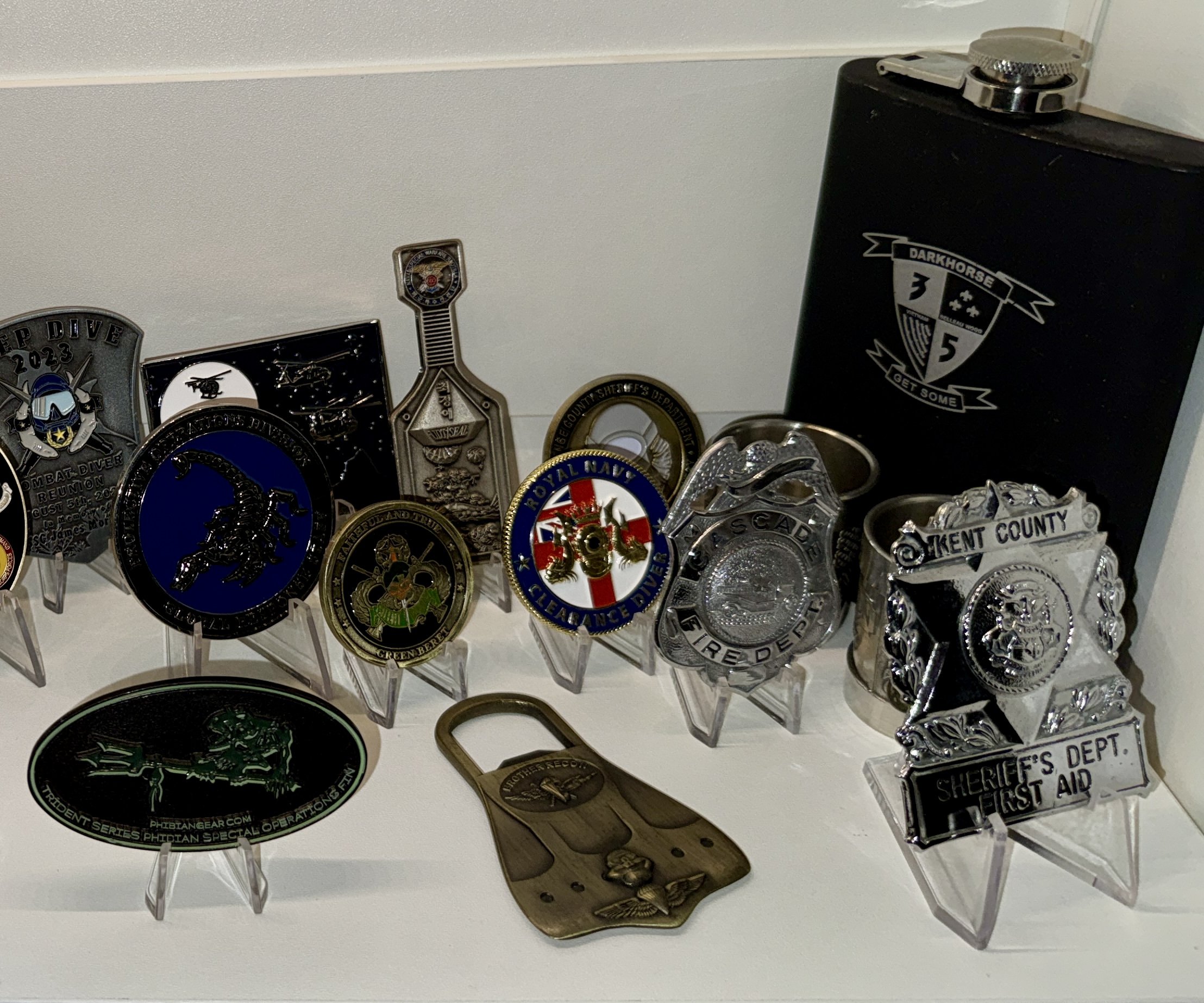 Frank L. Atherton’s Kent County Sheriff’s Department badges displayed at right with Phibian Gear and development-team memorabilia.