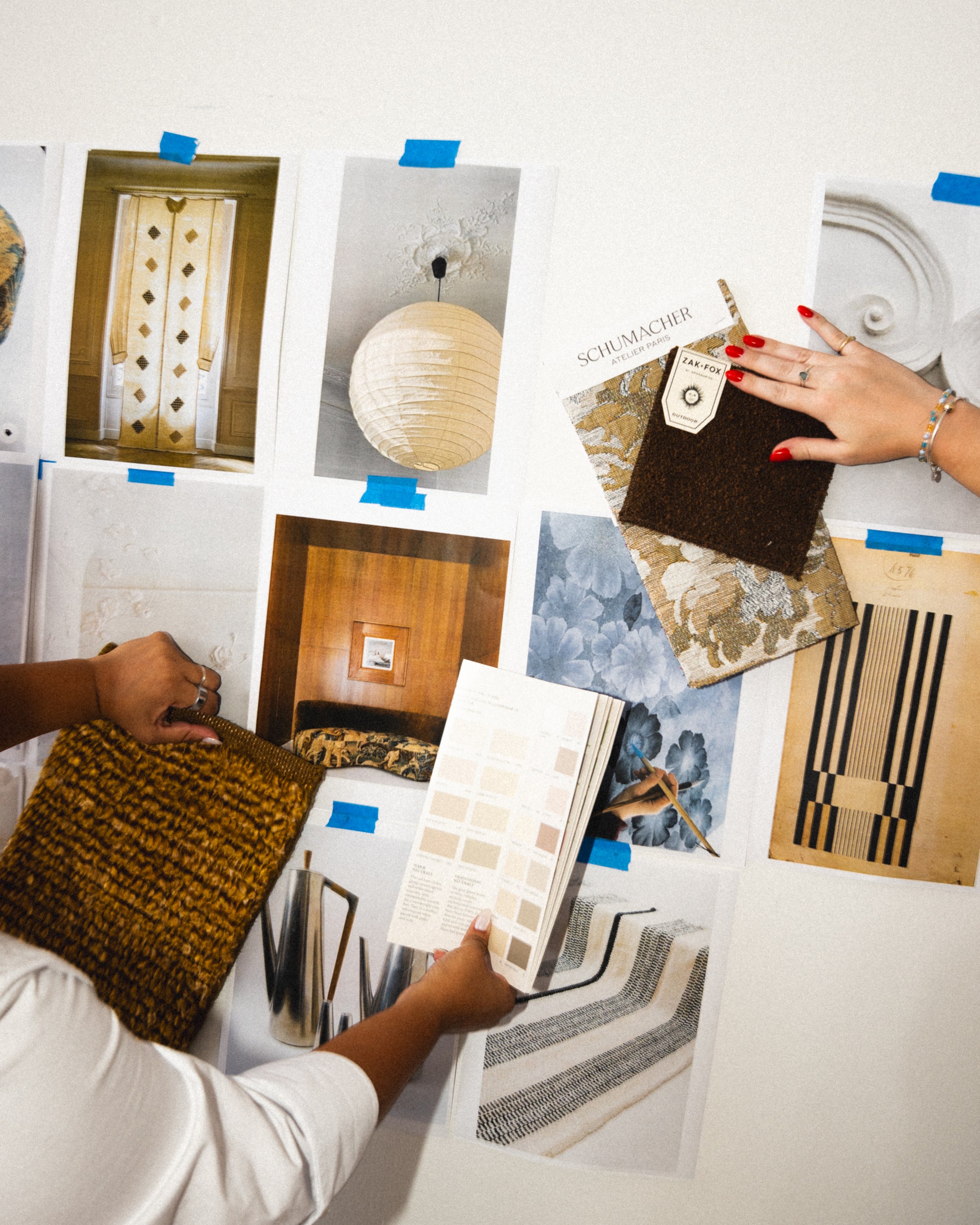 Reviewing custom textile swatches, luxury rug patterns, and material samples for interior design styling.