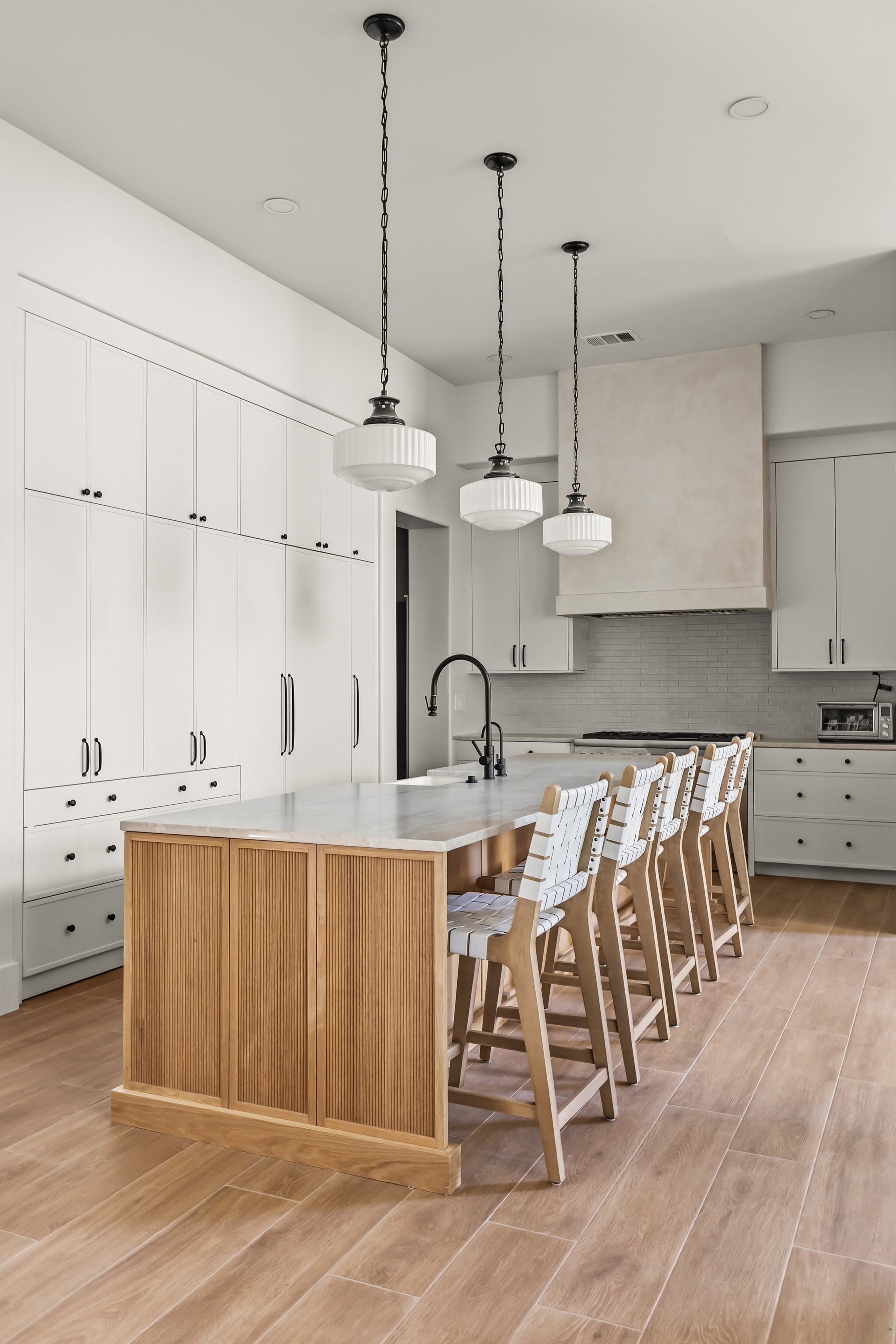 White kitchen with reeded walnut island