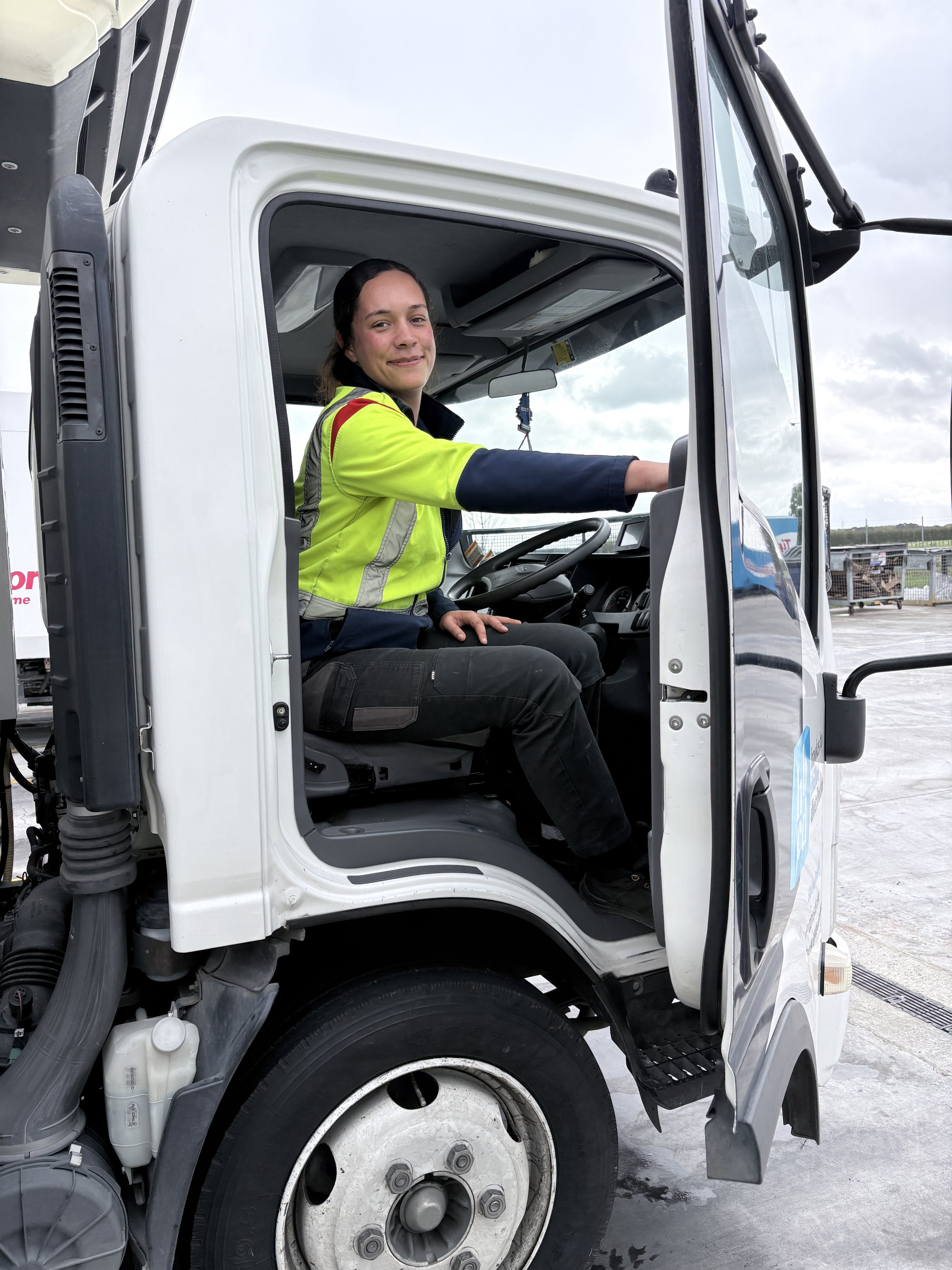 HBCD driver in the cab of a delivery truck
