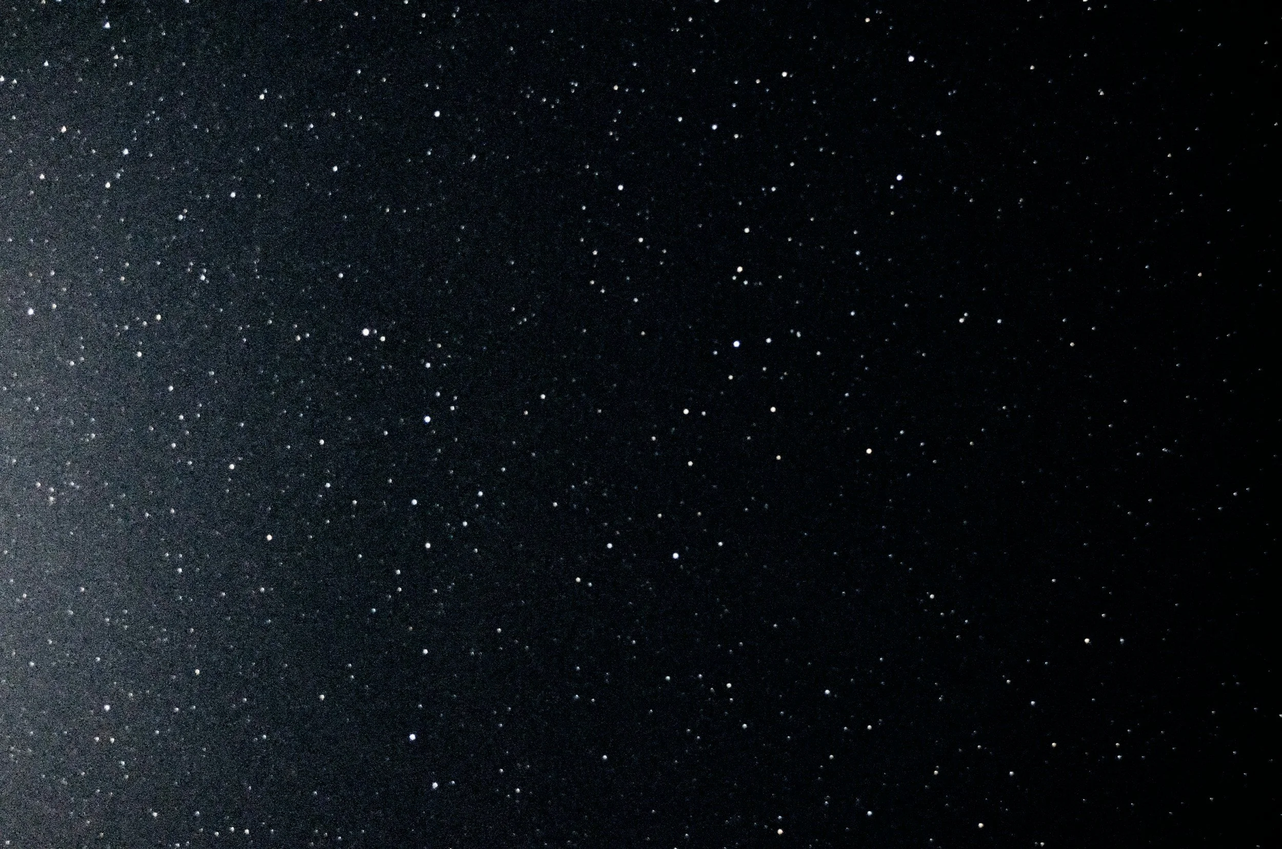 A starry night sky with numerous small white stars scattered across a dark background.