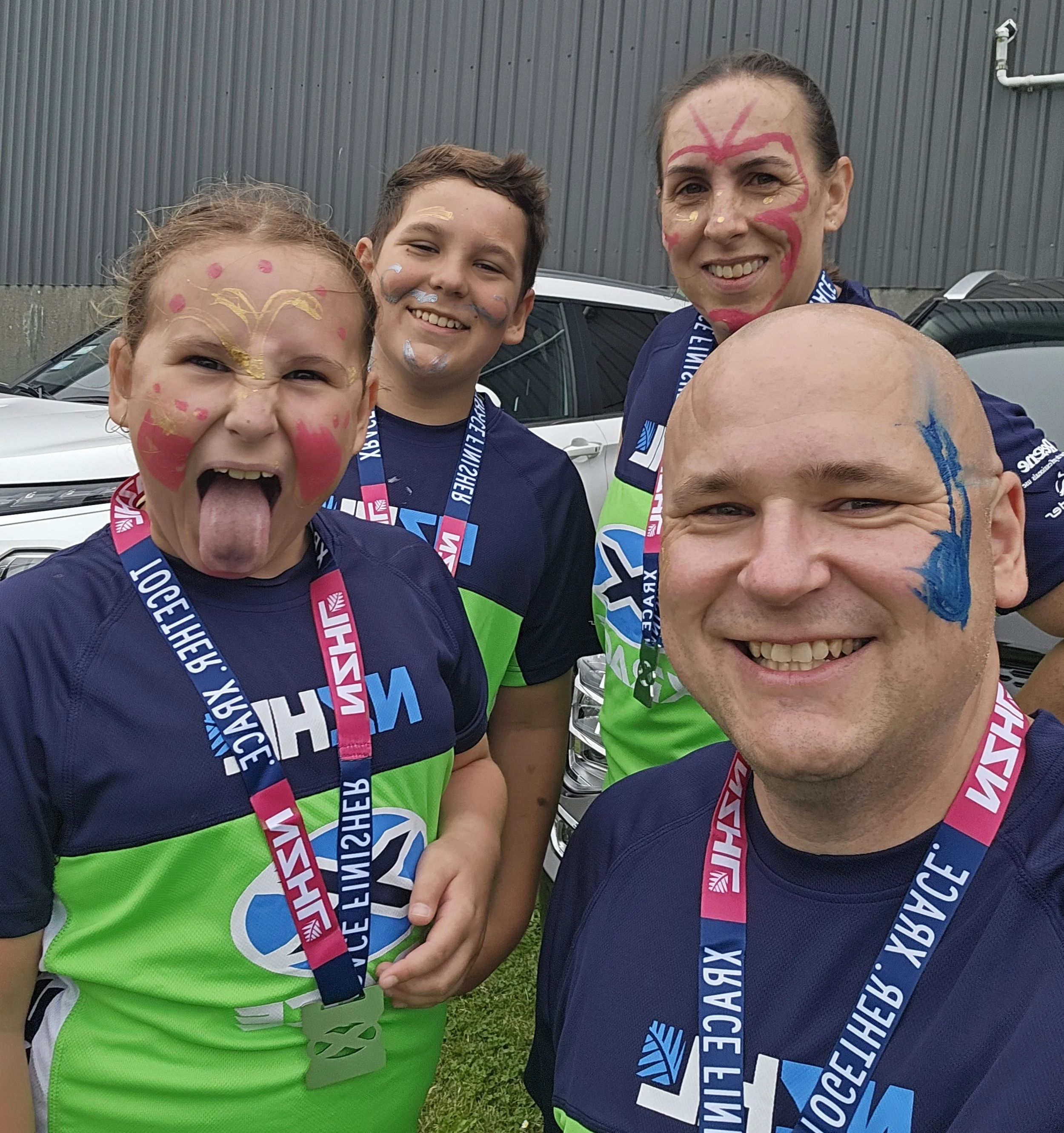 Blair Thompson, Porirua real estate agent, with his family after finishing an XRace event