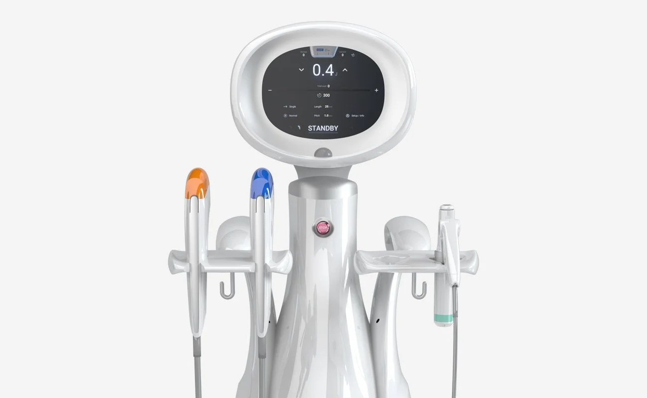 Medical robotic device with a digital display screen on top, surrounded by various medical instruments attached to its sides.