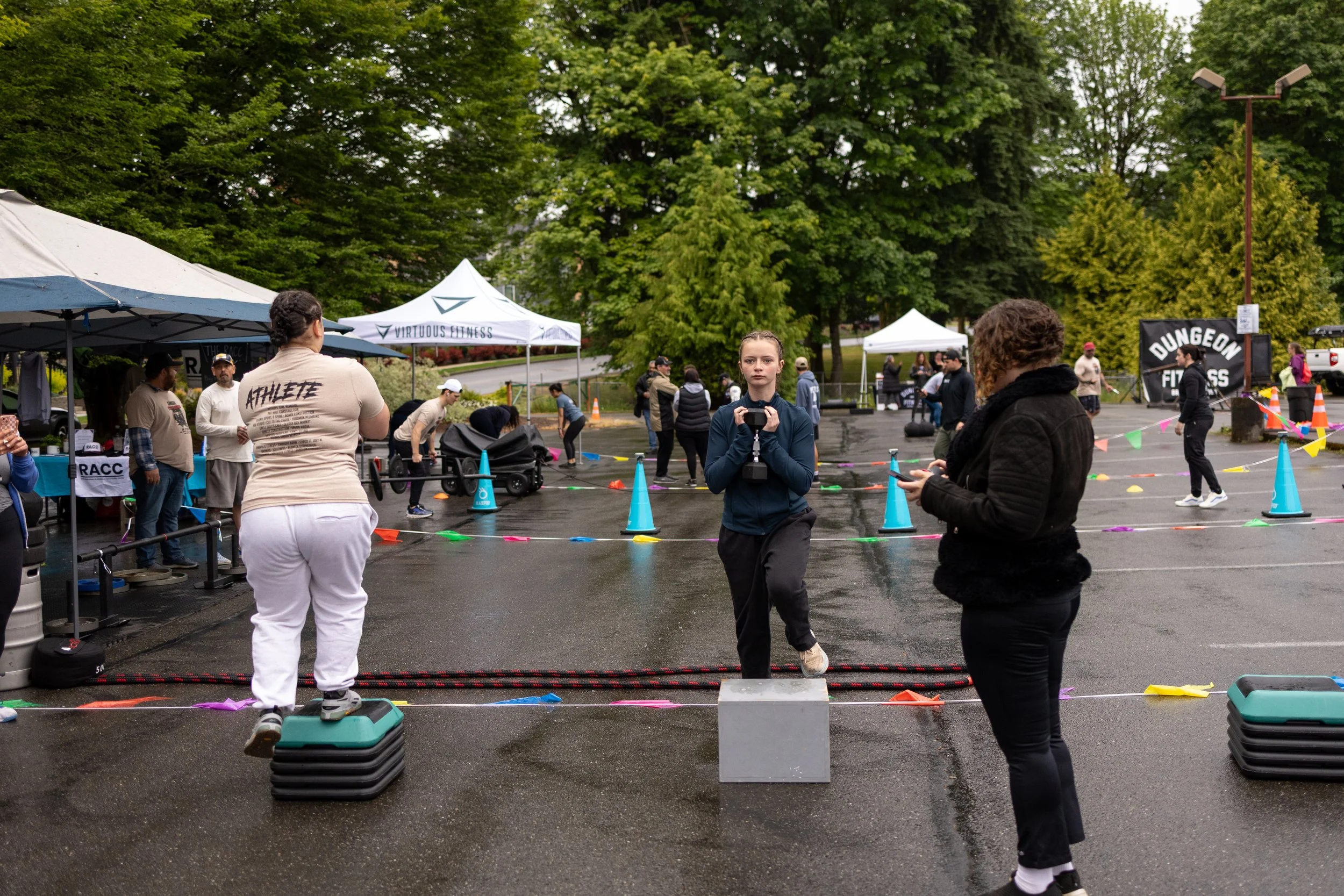 People participating in South Kitsap's Samson Fest fitness event. One woman is stepping onto a step platform, working out