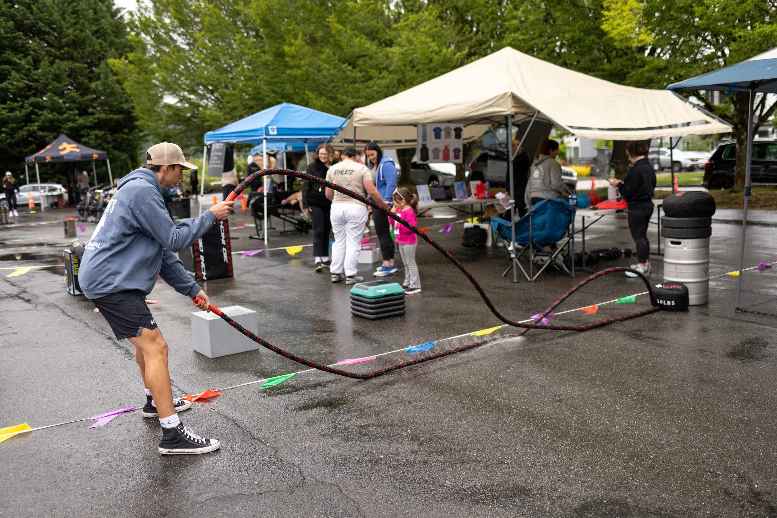 A teen boy is exercising with rope during Kitsap County's outdoor fitness event.