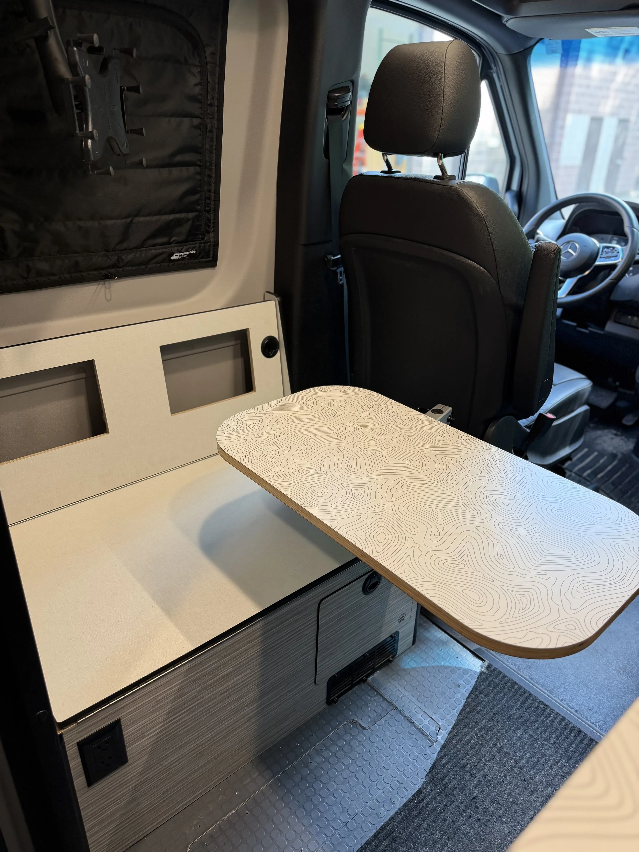 Lagun table mounts nicely to the side in a location that makes it usable from the new bench, along with the driver and passenger seat when they are swiveled