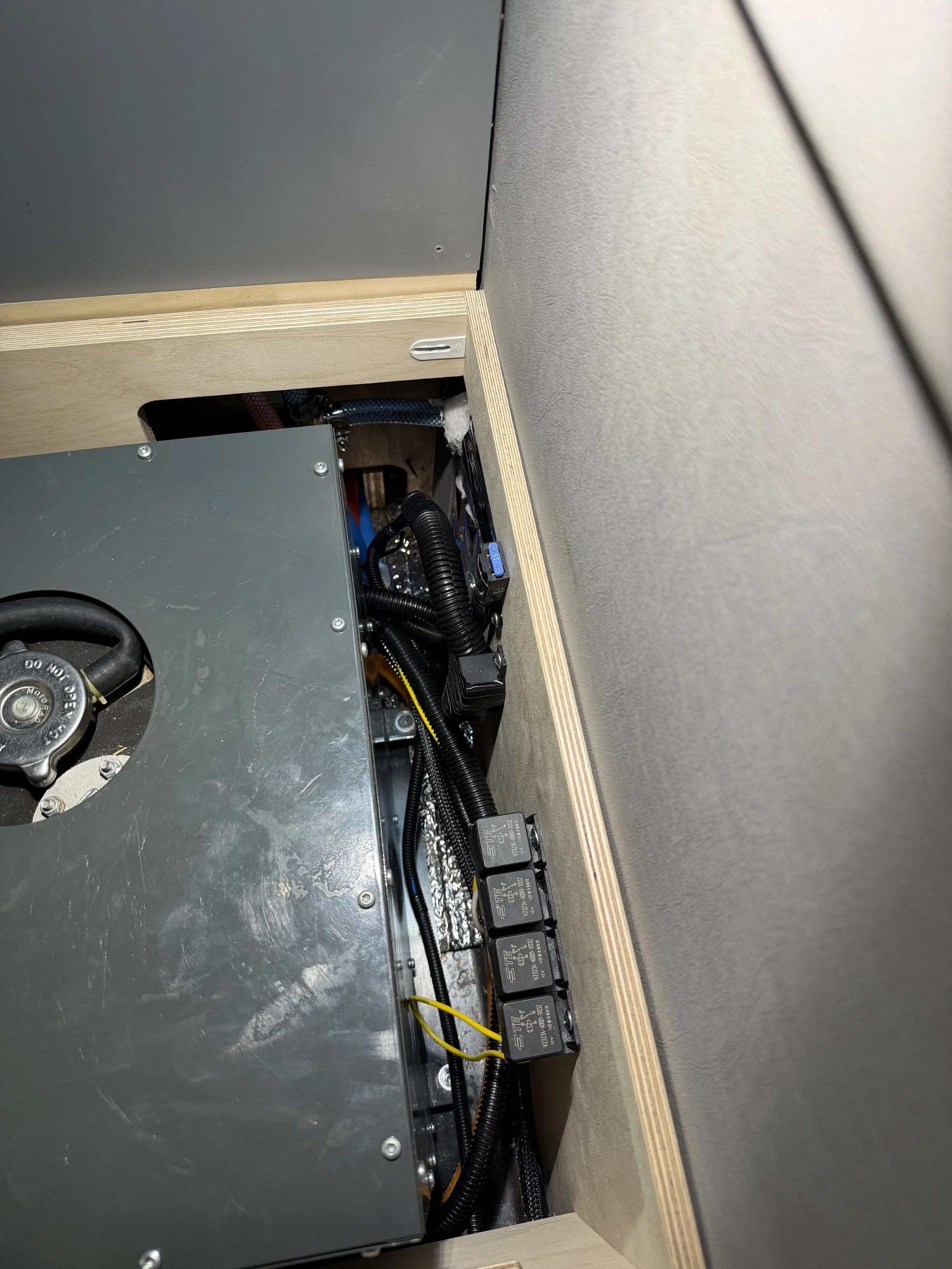 Fuses and Relays that were hidden under the jump seats are re-located to a spot that makes them accessible.