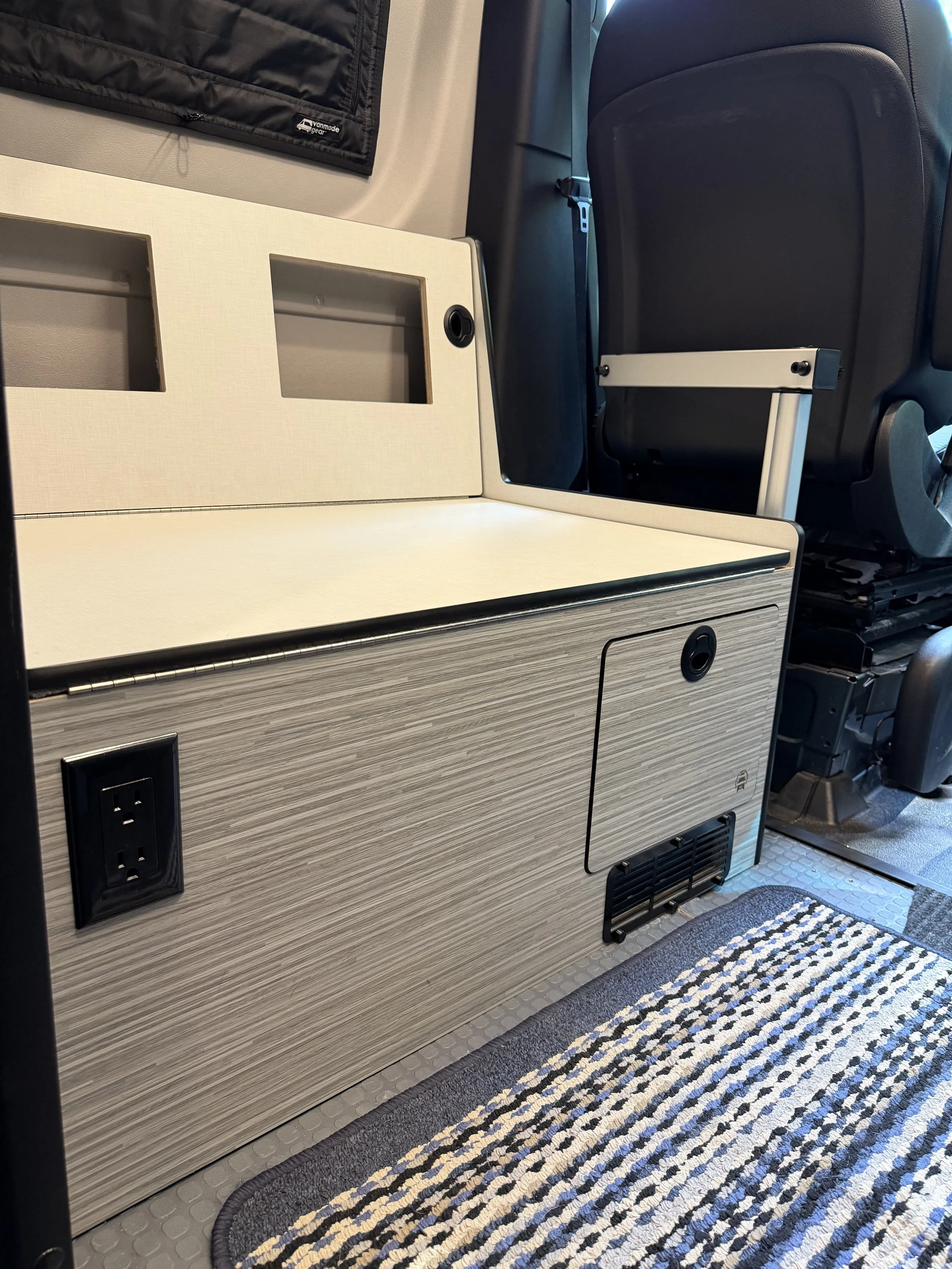 120v receptacle can be re-located to this location on the front of the bench. Or on the side of the bench right behind the driver seat
